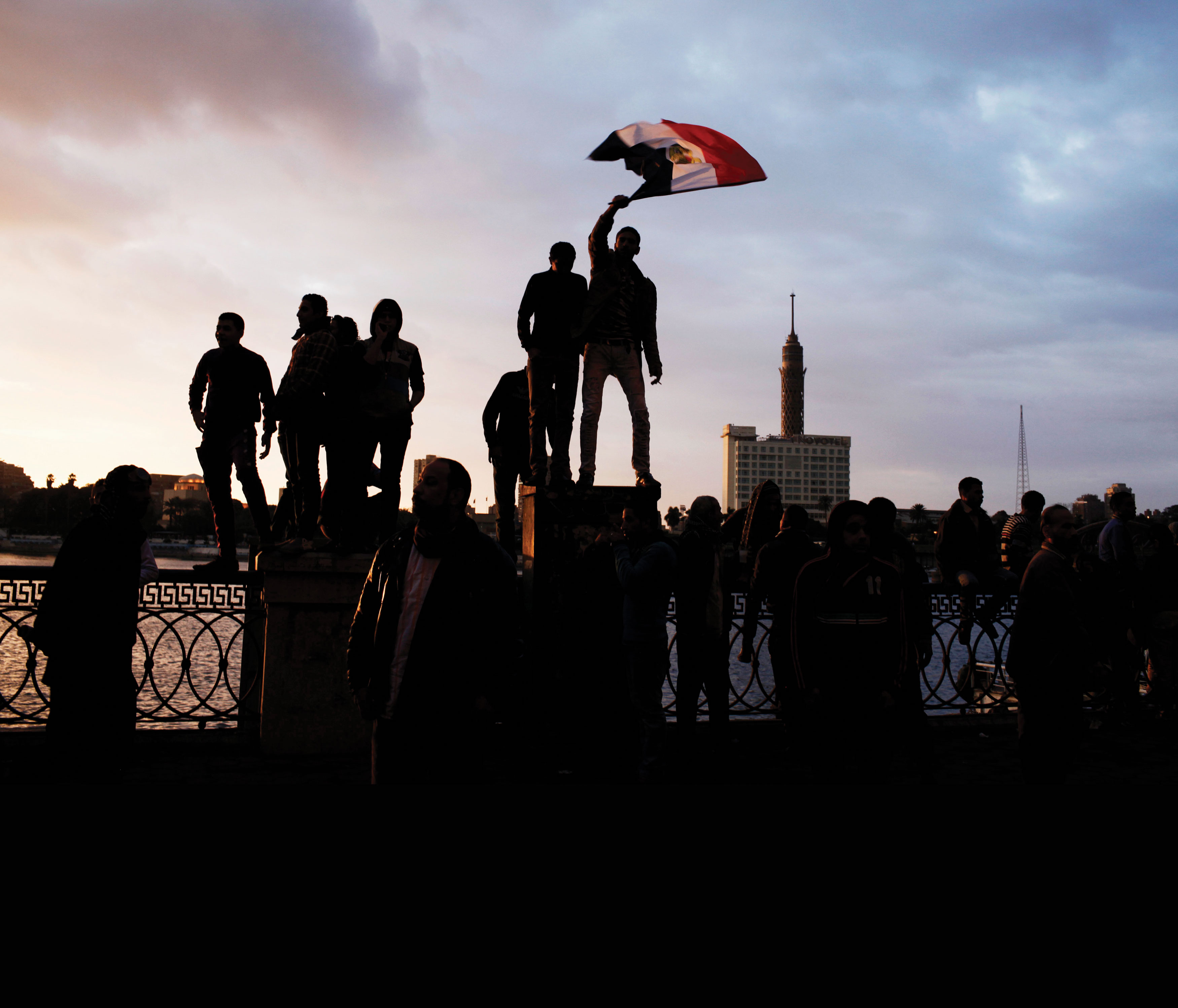 Photo of protester waving Egypt&#039;s flag.