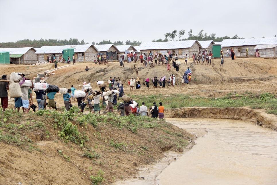 An image showing a group of Rohingya refugees relocating to safer areas from areas in the Kutupalong settlement at risk of landslides and floods