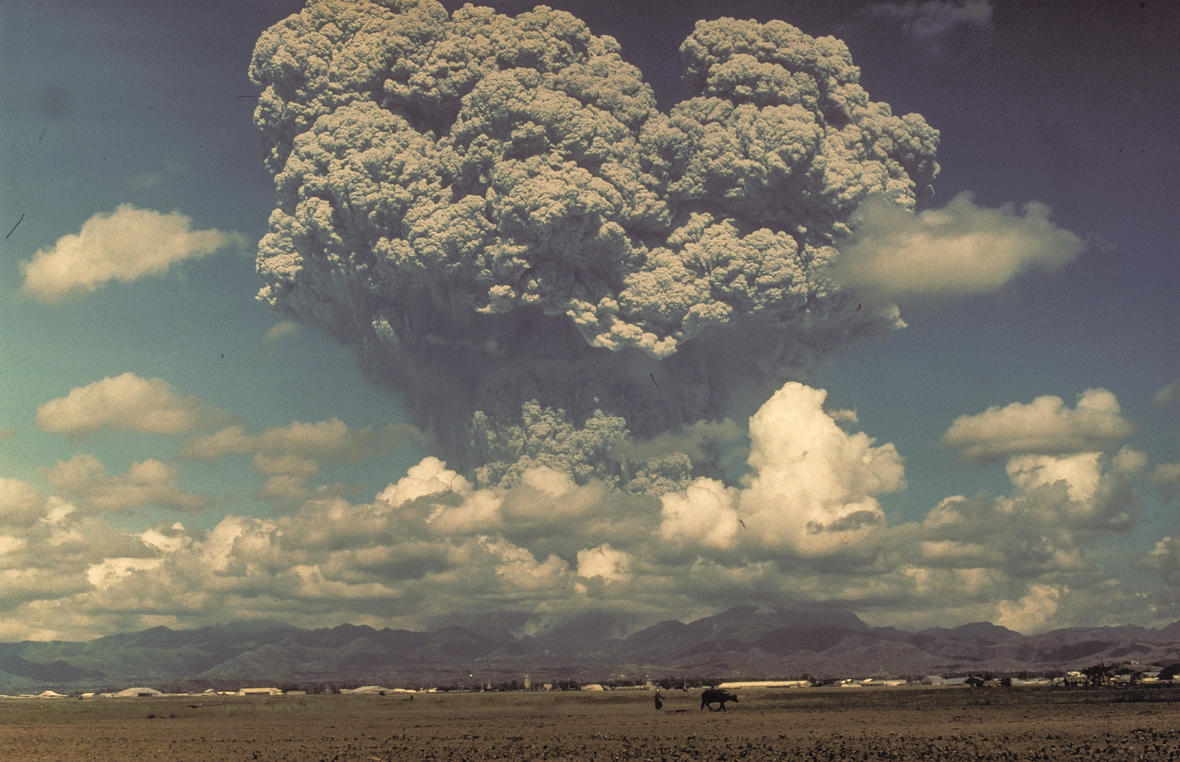 Giant ash cloud from the eruption of Mount Pinatubo, 1991 towering above farms and agricultural lands in the Philippines.