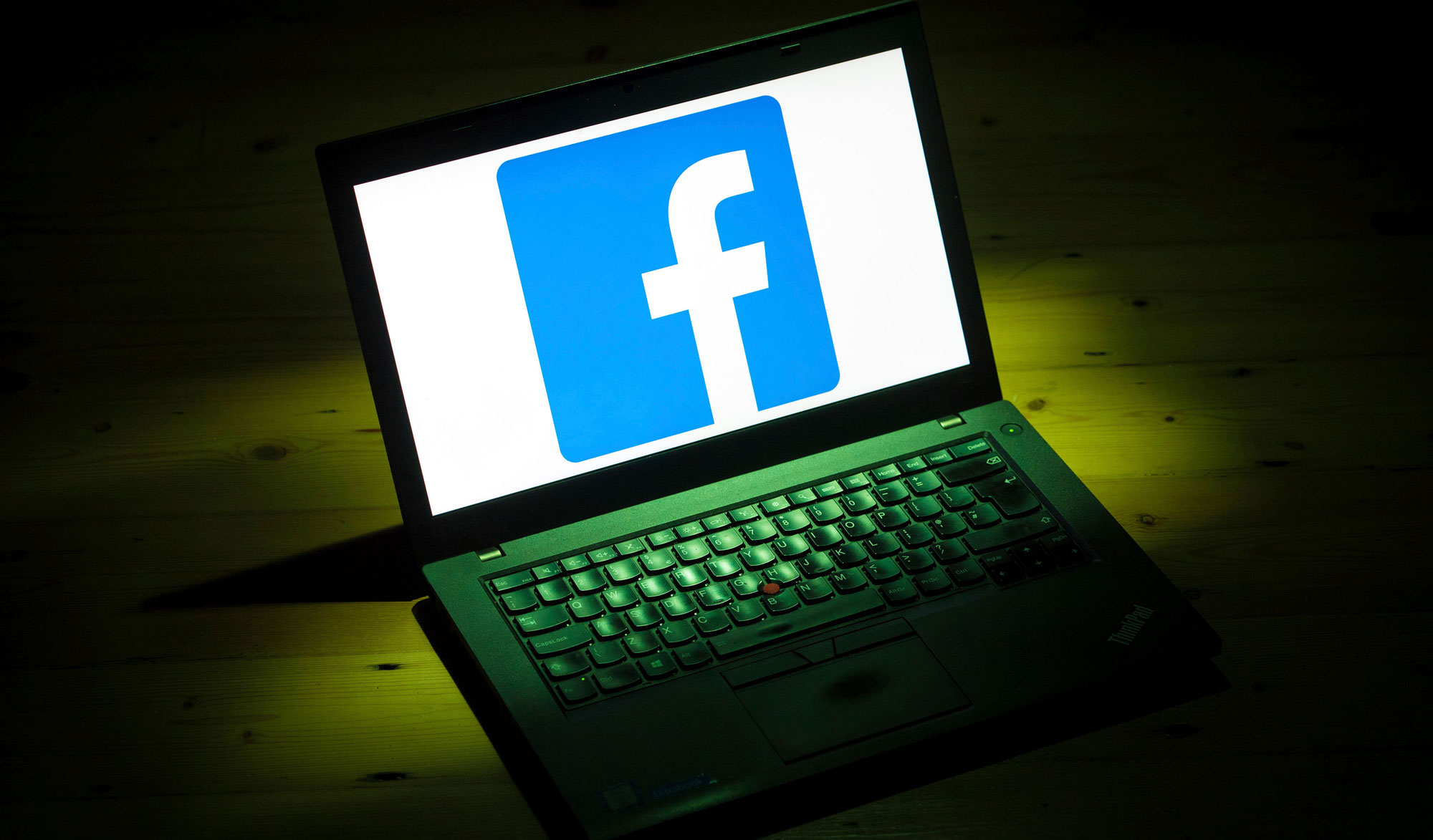 Facebook&#039;s logo taking up an entire open laptop screen
