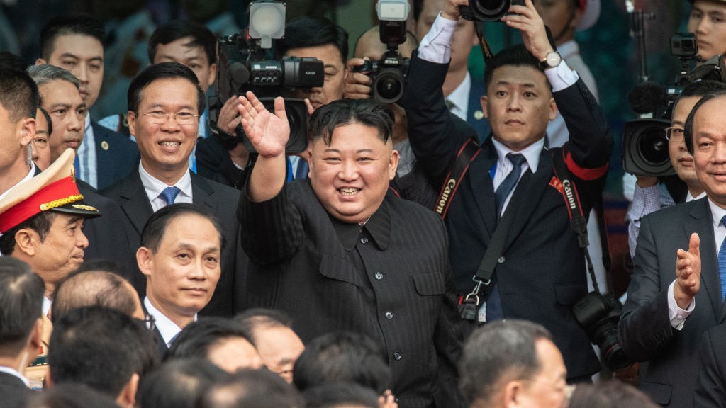 North Korean leader Kim Jong-un waves to photographers.