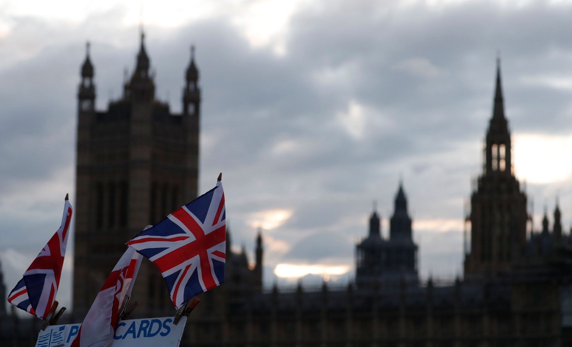 UK flags fly in front of the British Parliament