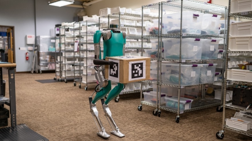 A two-legged robot holding a package