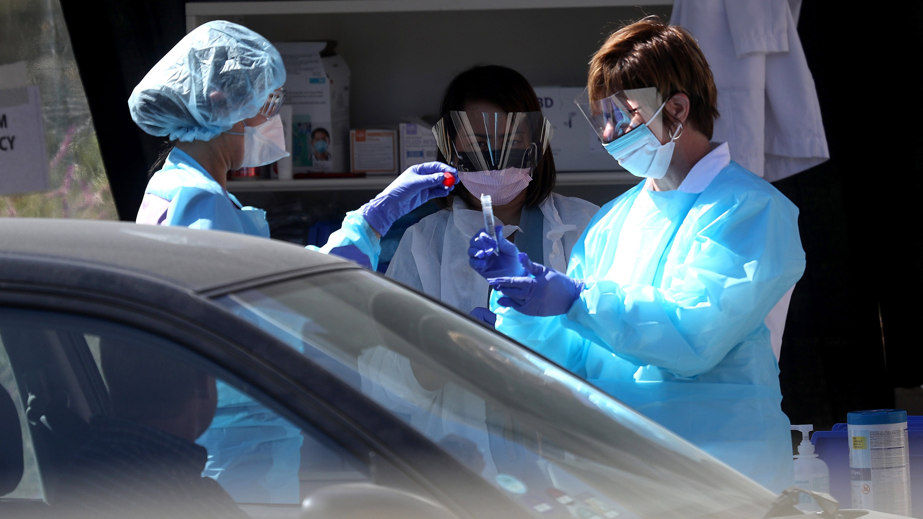 Medical personnel obtain samples at a drive-thru coronavirus testing station in San Francisco.