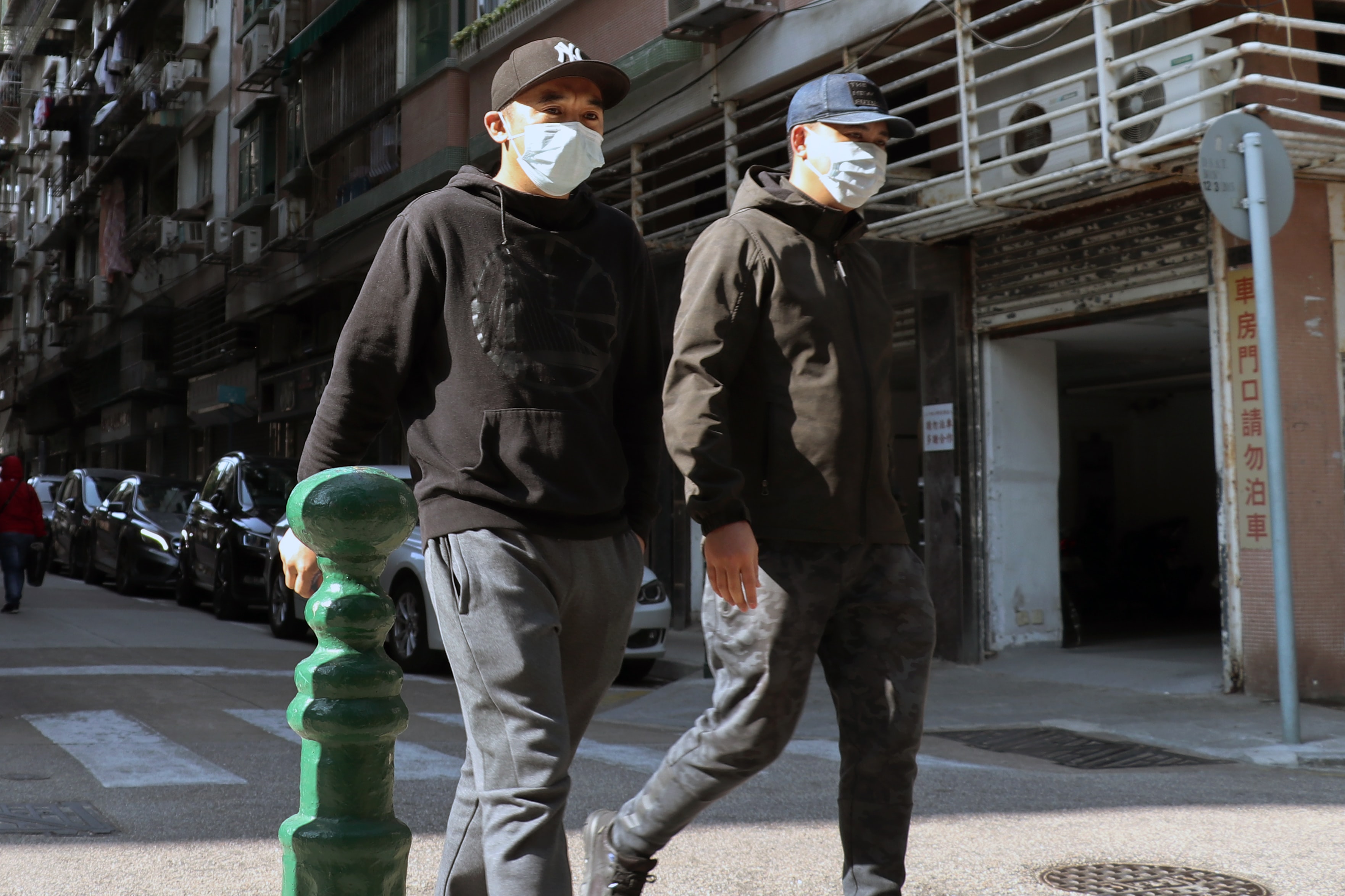 People walk on the street in Macau wearing face masks to protect themselves from coronavirus.
