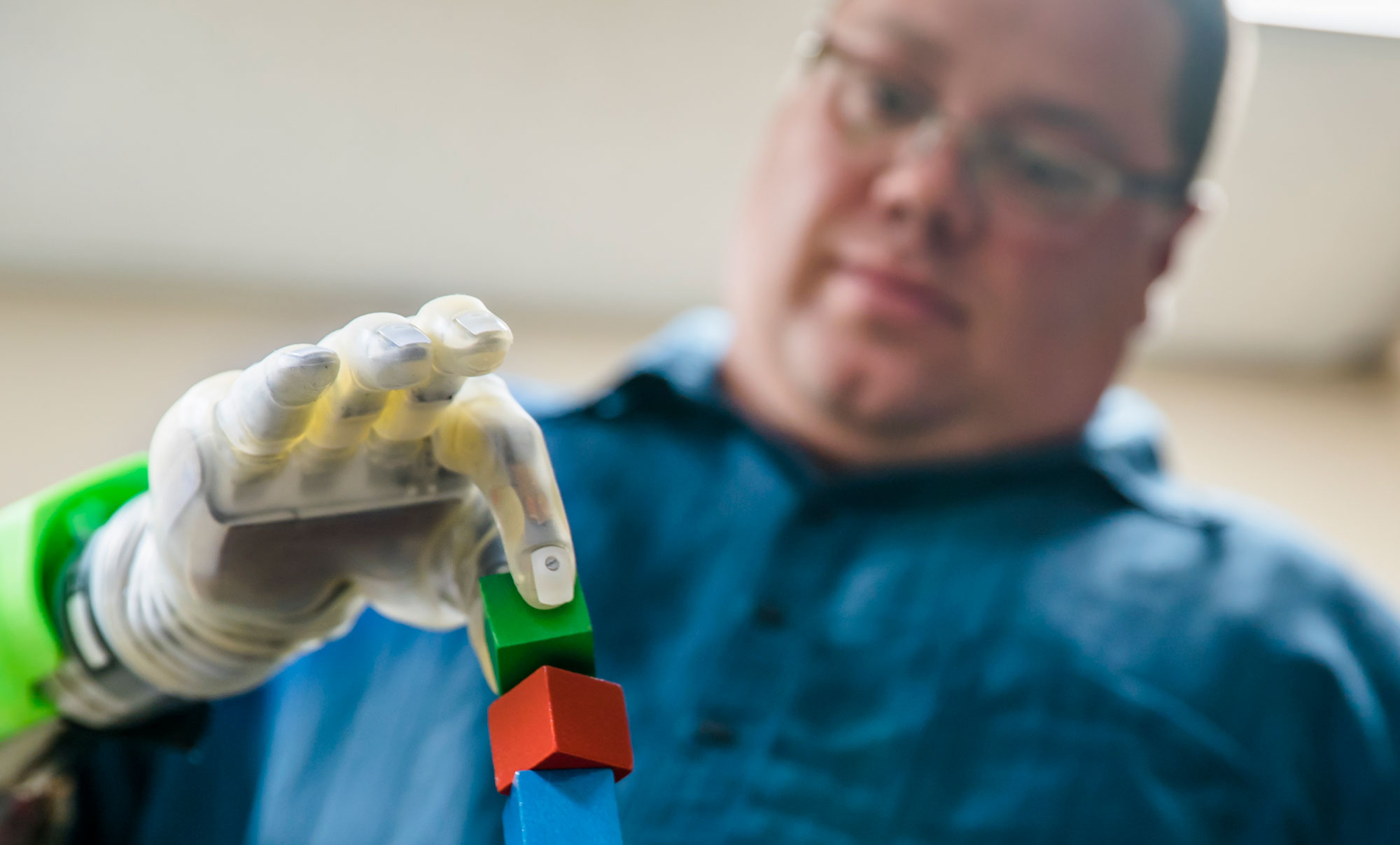 Joe Hamilton, a participant in the University of Michigan RPNI study, uses his mind to
control a DEKA prosthetic hand to pick up a small block