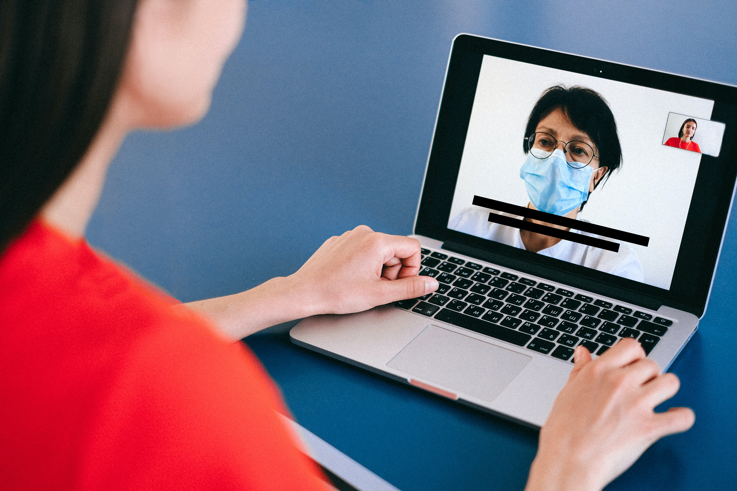 image of woman in red shirt looking at computer with person in mask and black subtitle text beneath image deaf hard of hearing dhh coronavirus pandemic clear mask live transcribe transcription