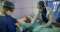 Doctors attend a coronavirus patient who is receiving oxygen