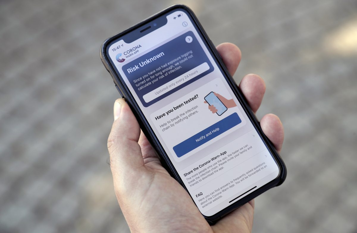 A person holds a smartphone with the official 'Corona Warn-App' (Corona Warning Application) in Berlin, Germany, Monday, June 15, 2020. The app will be introduced on Tuesday, June 16 by the German authorities.