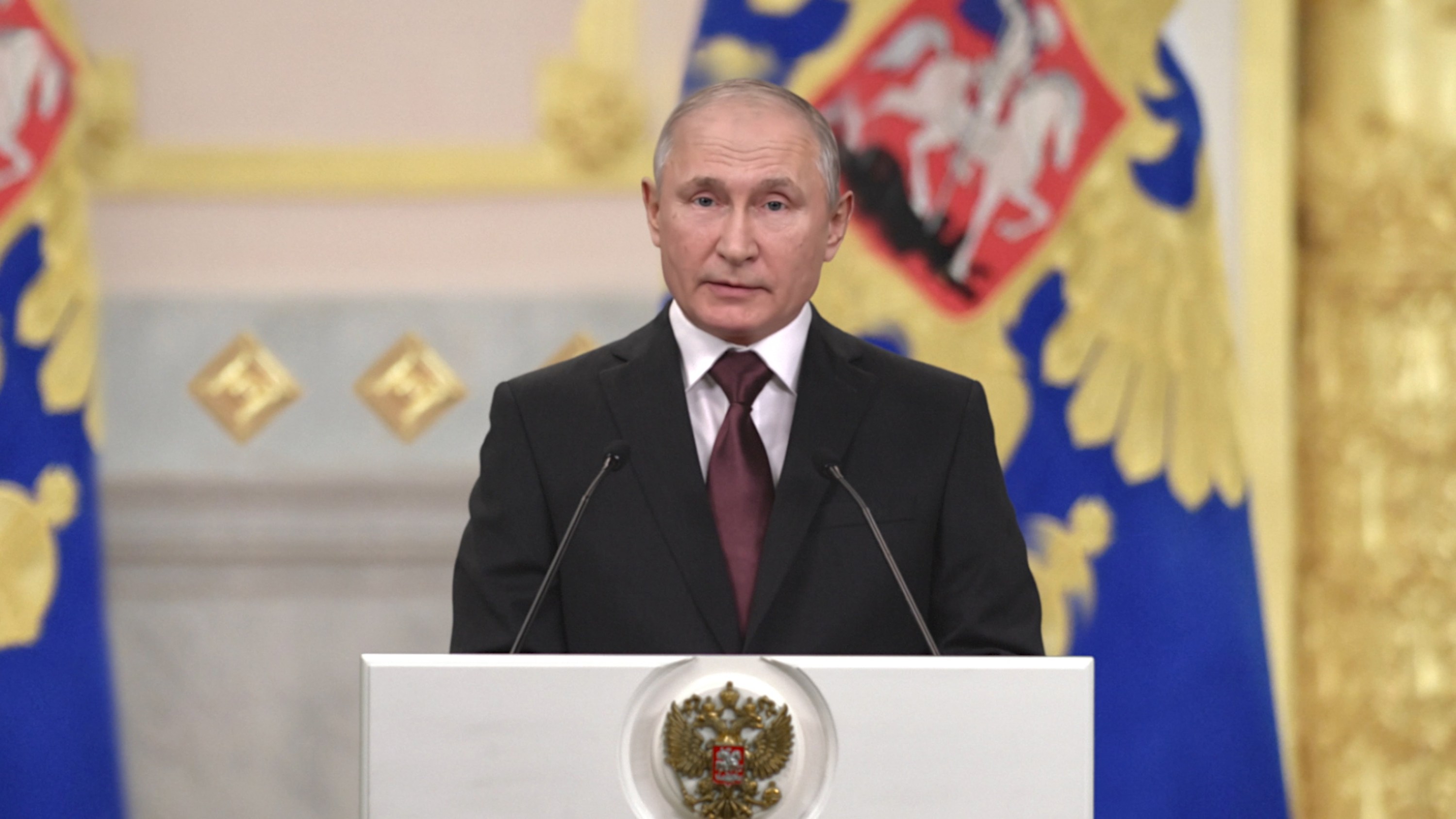 A deepfake of Putin standing at a podium.