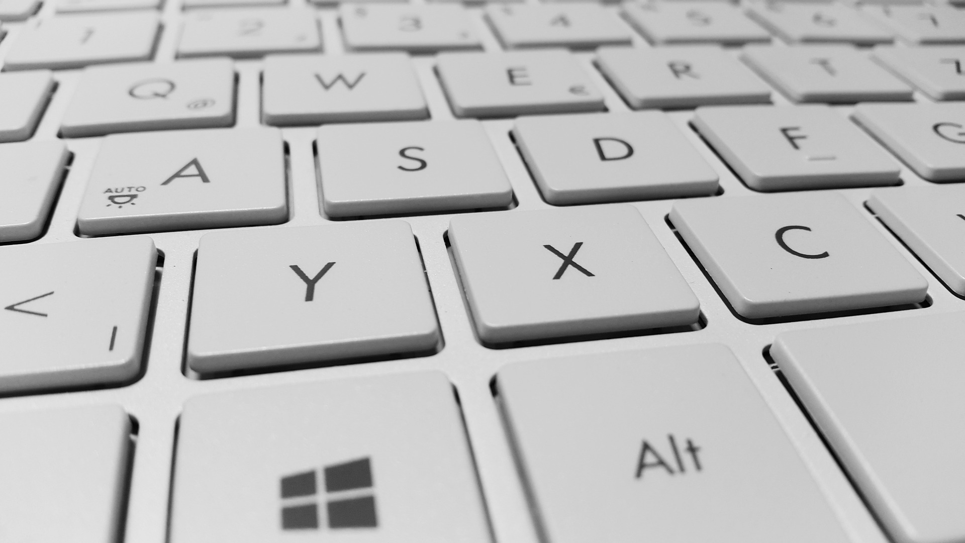 A zoomed-in shot shows keys on a white keyboard.