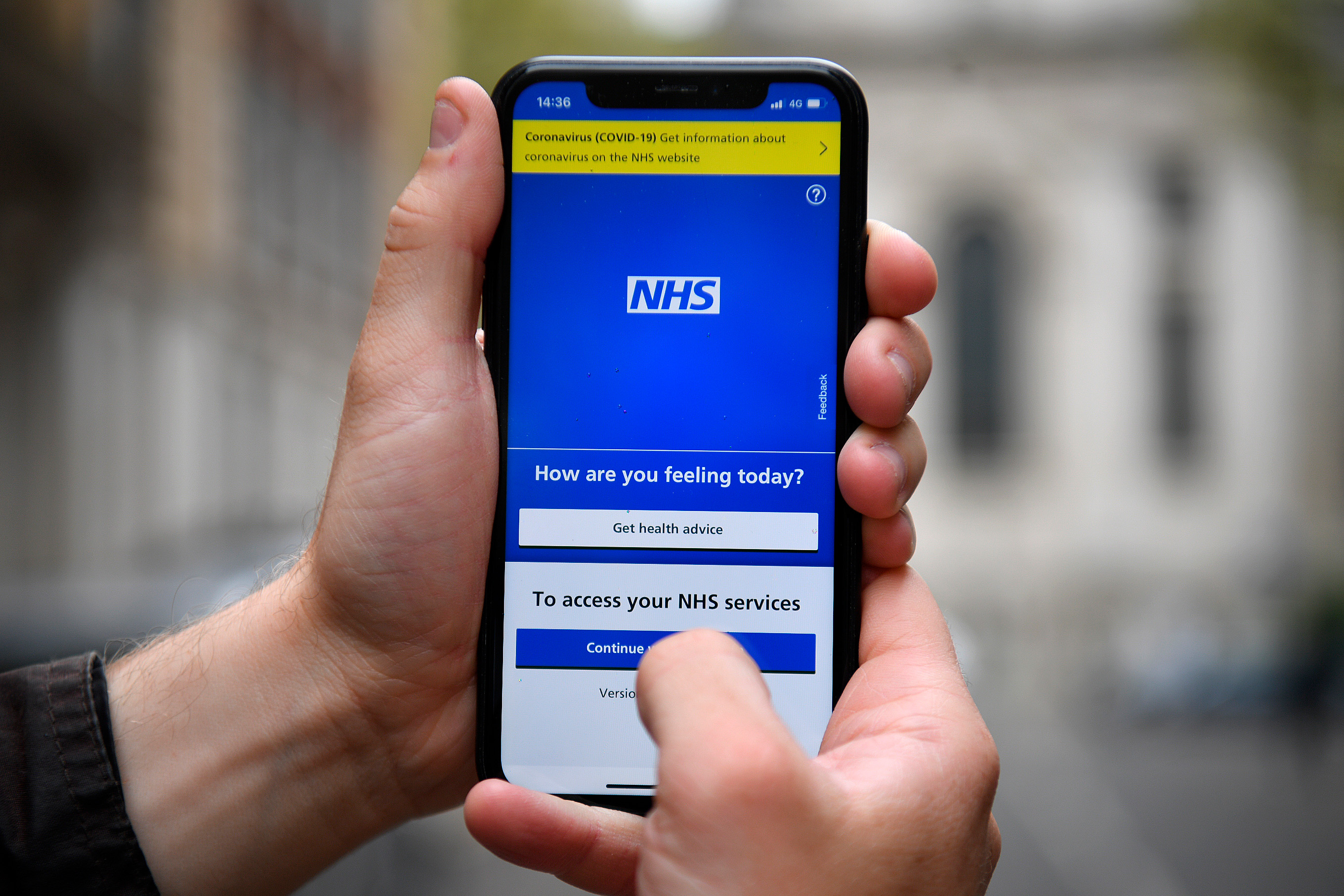 person showing NHS app on phone