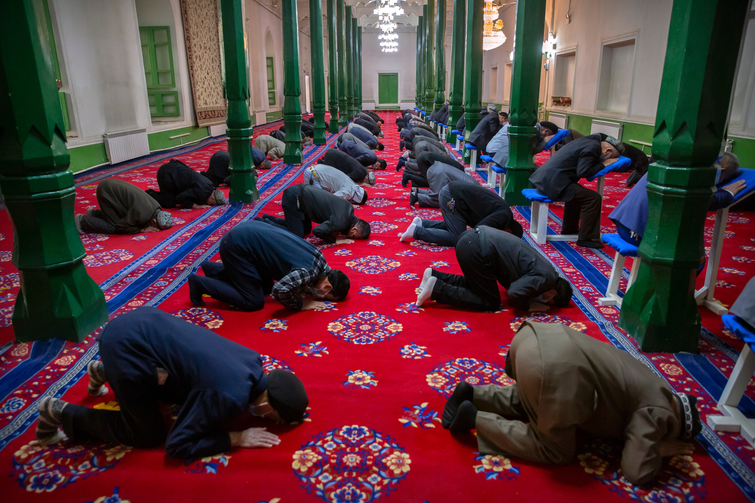 Uyghurs and other members of the faithful pray during services at the Id Kah Mosque in Kashgar in western China's Xinjiang Uyghur Autonomous Region, as seen during a government organized visit for foreign journalists on April 19, 2021. Under the weight of official policies, the future of Islam appears precarious in Xinjiang, a remote region facing Central Asia in China's northwest corner. Outside observers say scores of mosques have been demolished, which Beijing denies, and locals say the number of worshippers is on the decline.