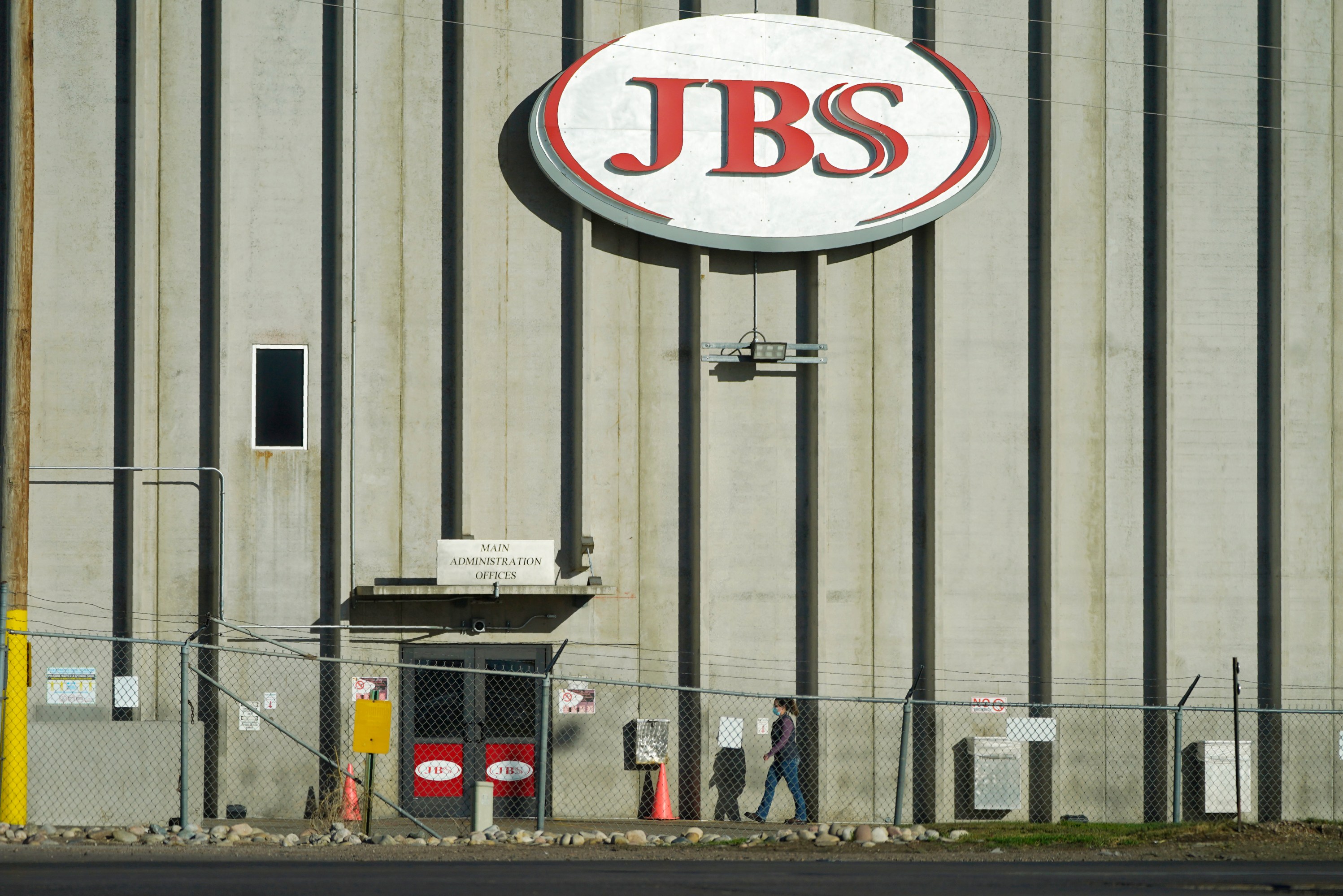 In this Oct. 12, 2020 file photo, a worker heads into the JBS meatpacking plant in Greeley, Colo. A weekend ransomware attack on the world’s largest meat company is disrupting production around the world just weeks after a similar incident shut down a U.S. oil pipeline.