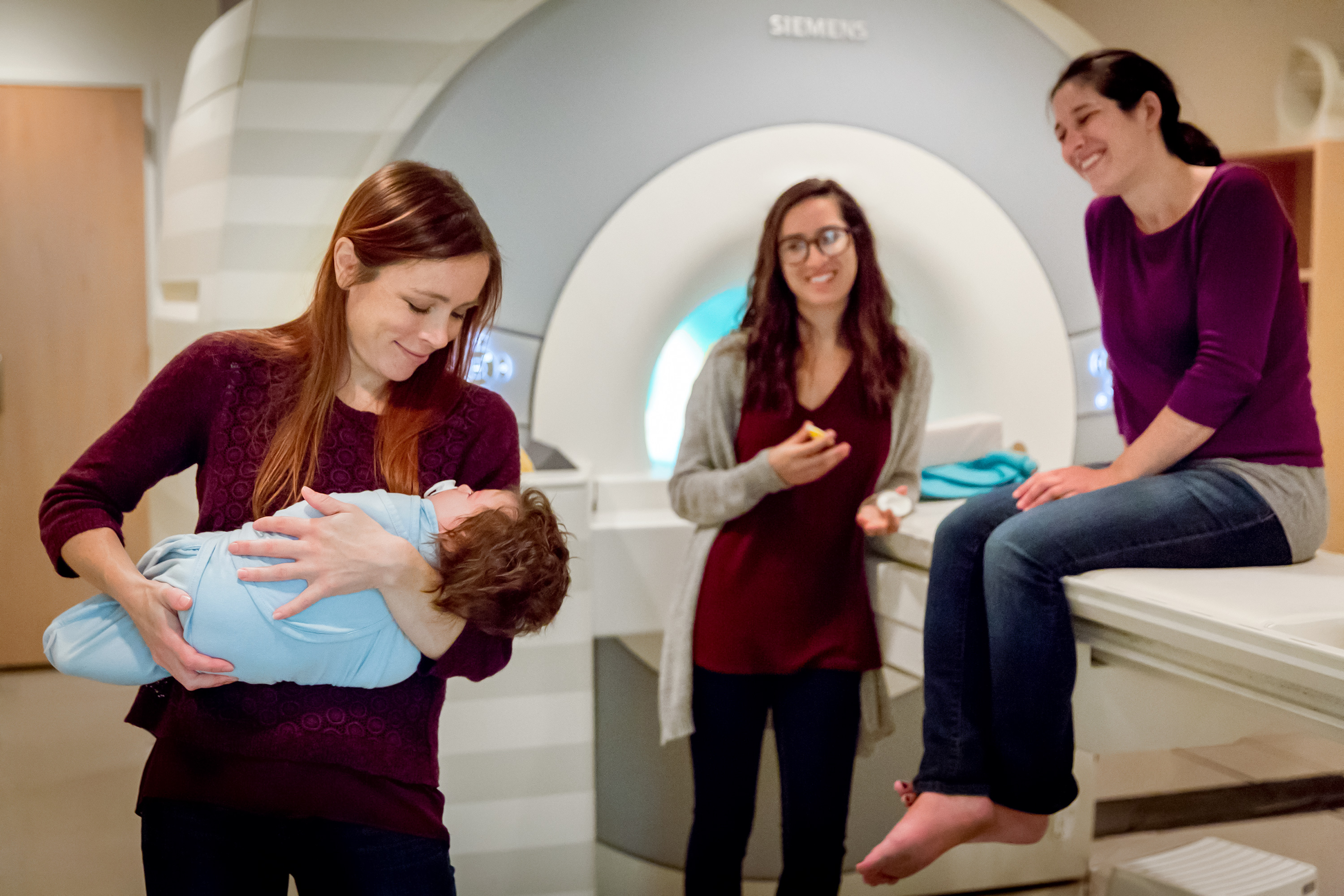 Heather Kosakowski holds an infant who is about to be scanned in an fMRI machine at the McGovern Institute for
Brain Research.