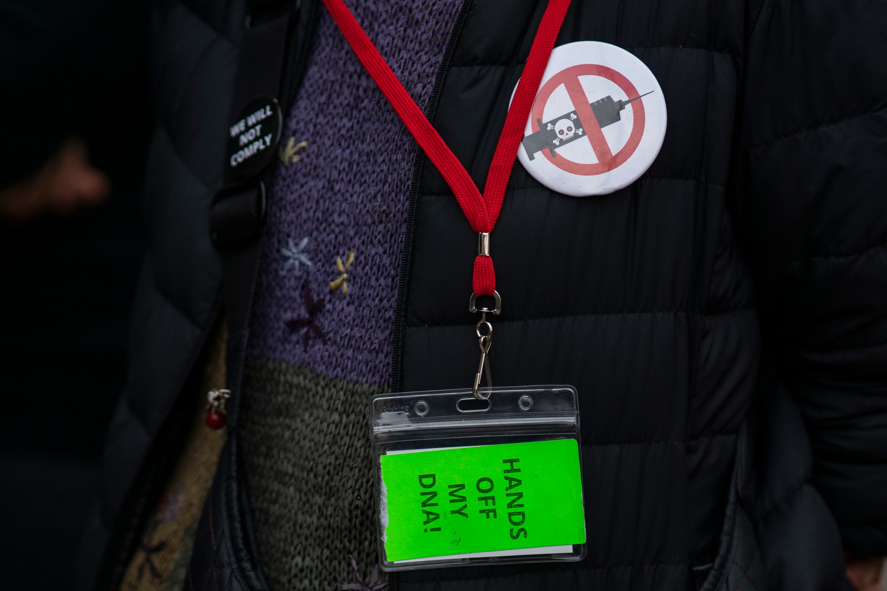 photograph of someones badge saying "hands off my dna!"