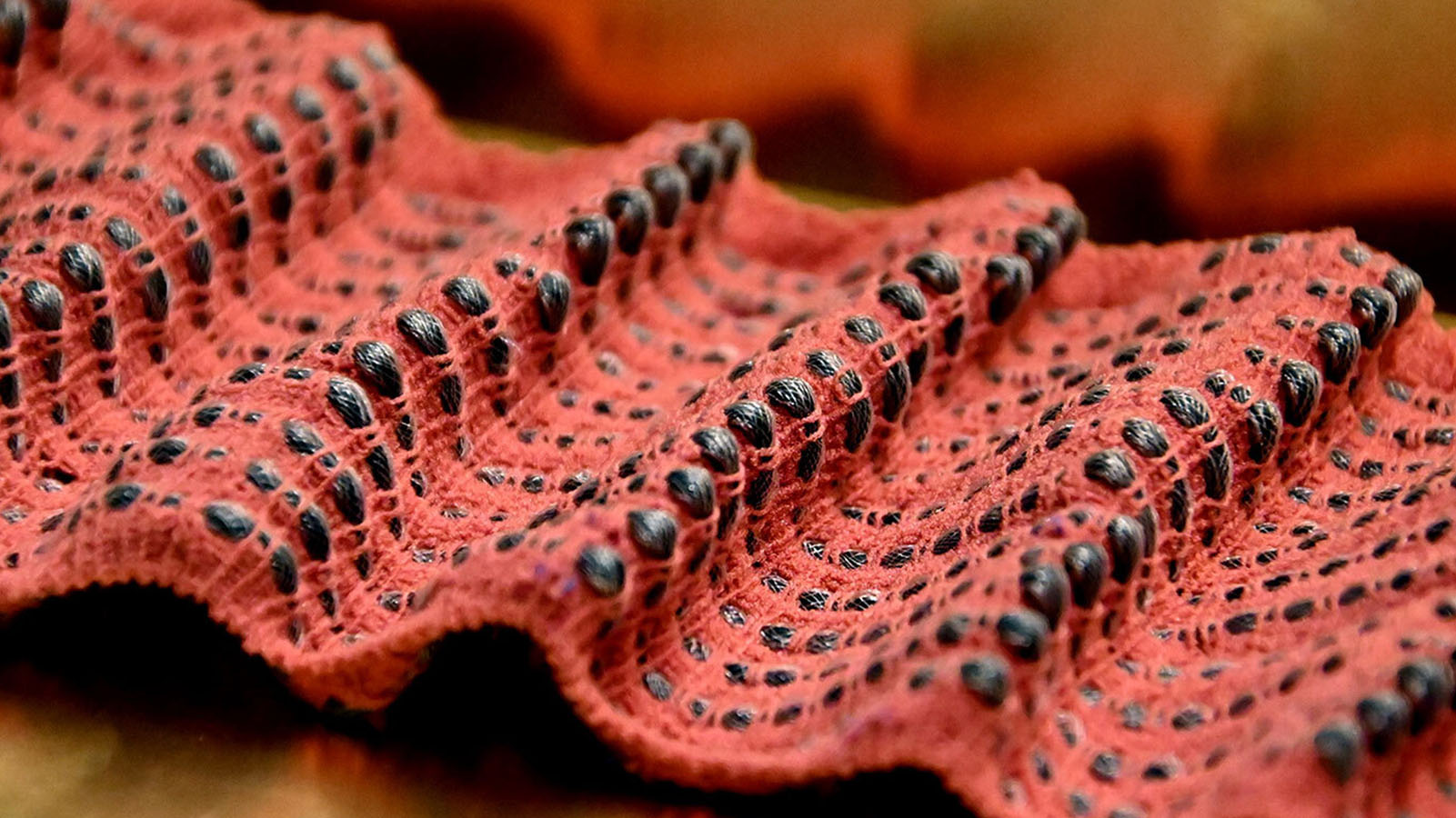 Fabrics like this, woven from soft robotic fibers that can sense and respond to their own
deformation, could be made into garments that
provide tactile feedback, guiding a wearer’s breath and body position.