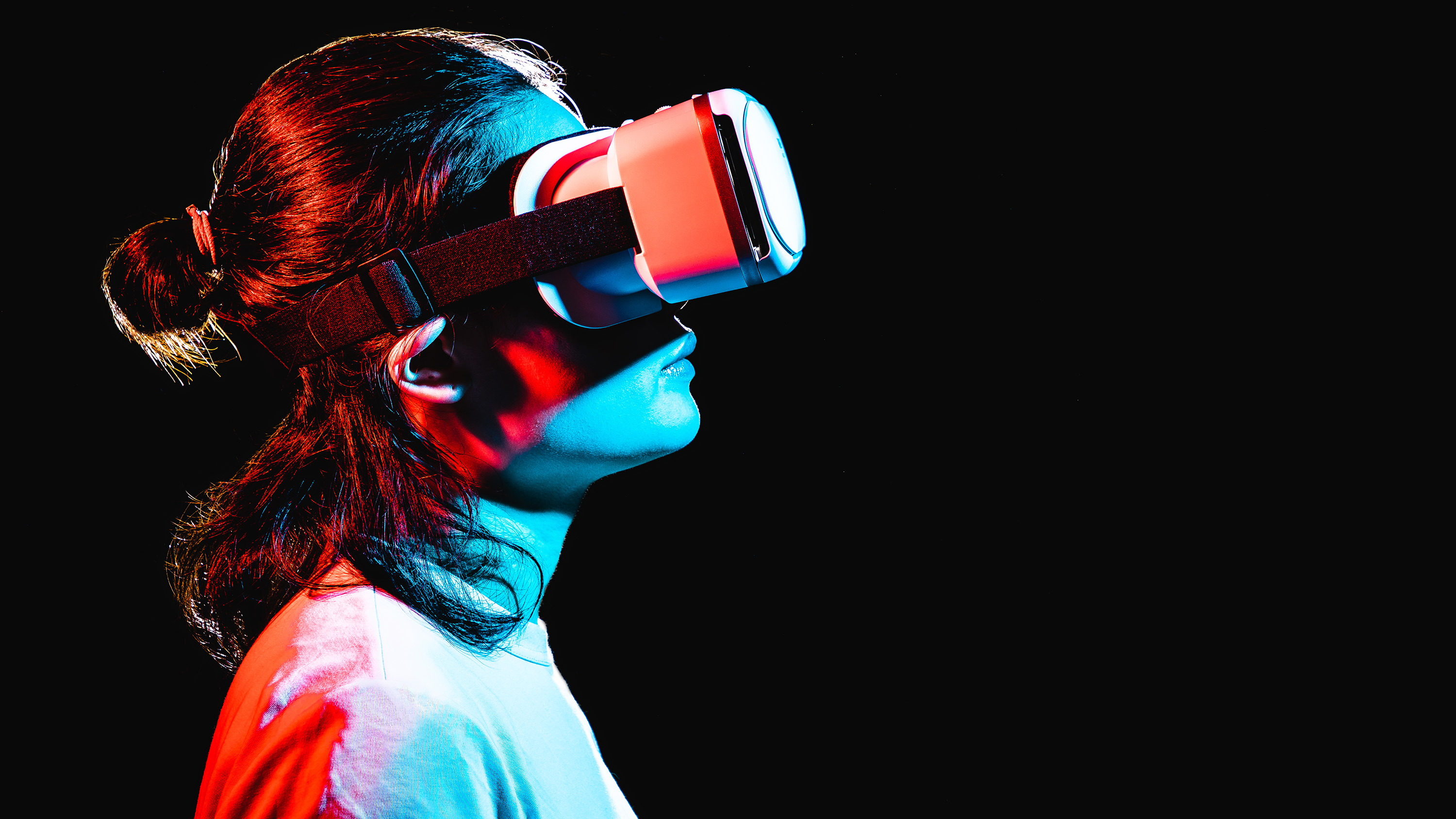 Woman using Virtual Reality headset at night