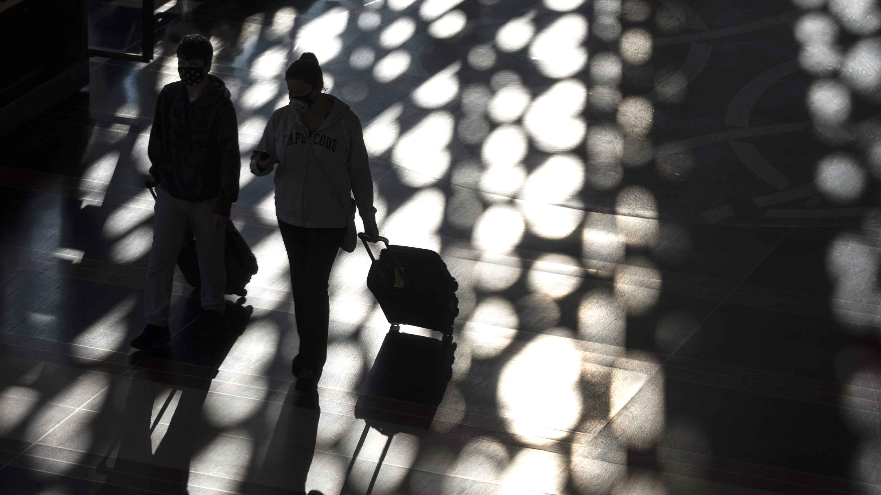 travelers walk through Ronald Reagan Washington National Airport
