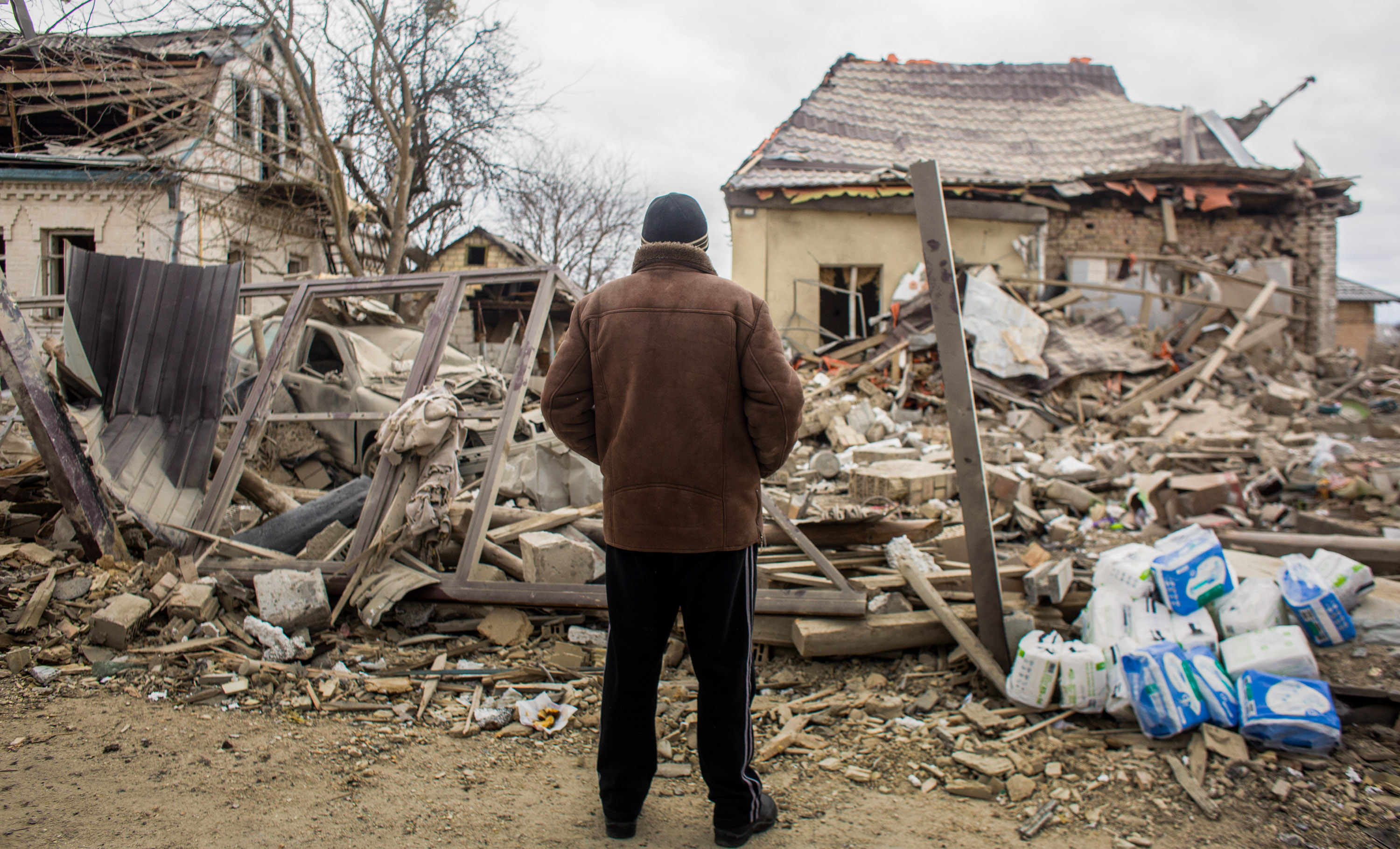 On March 5, 2022, a local resident looks at the shell area in Markhalivka, Ukraine.