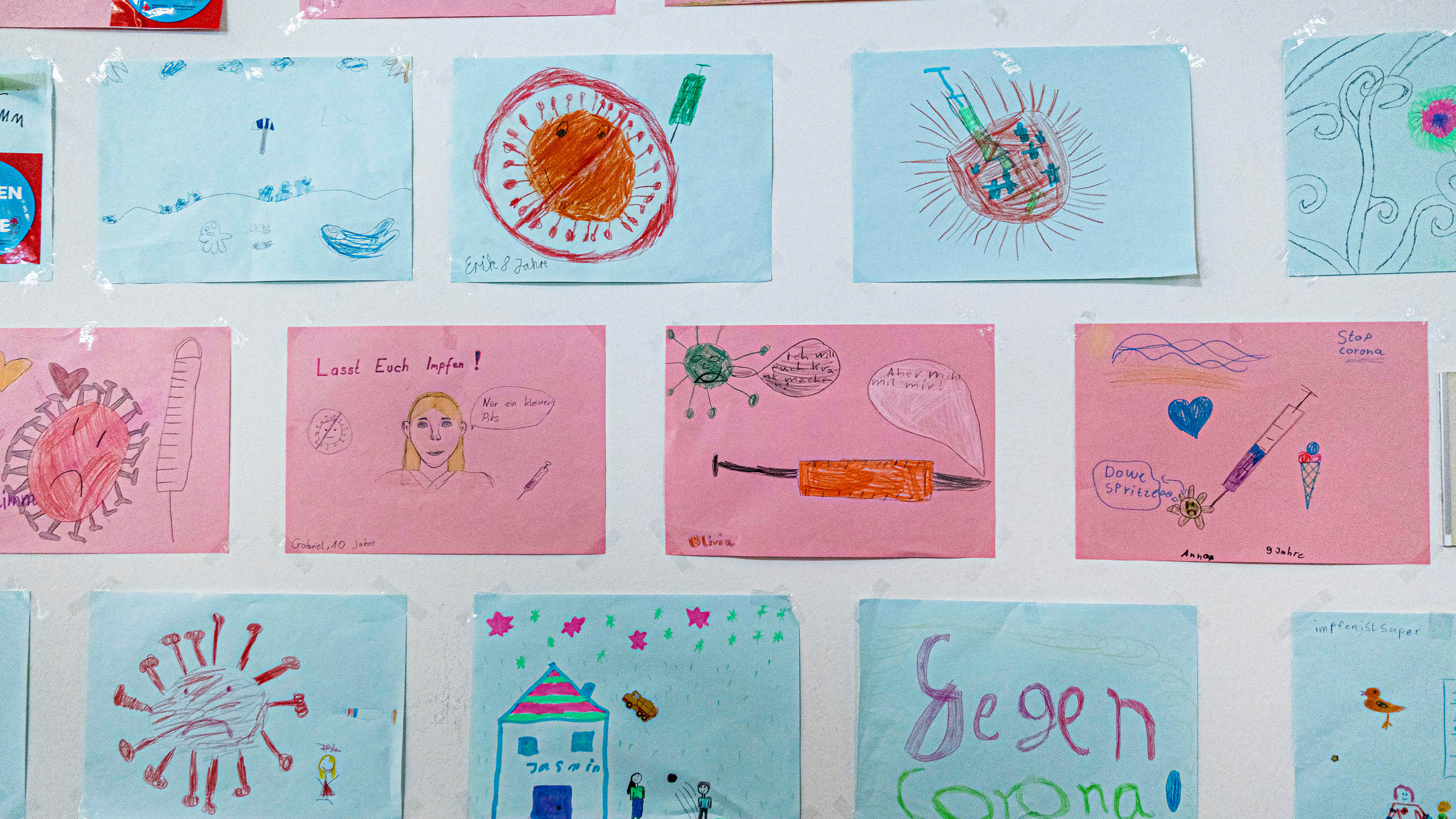 Pictures drawn by children are displayed on one wall at the Tegel vaccination center in Germany