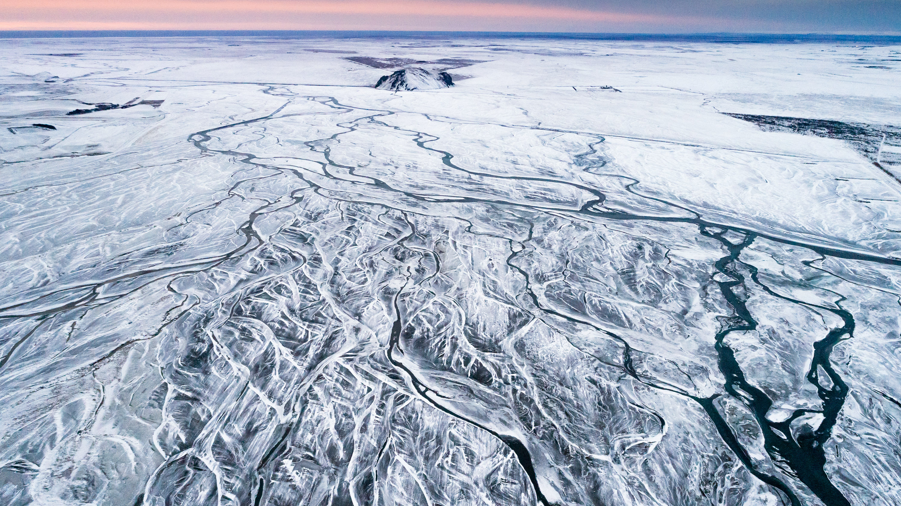 Icelandic winter landscape with a frozen braided river