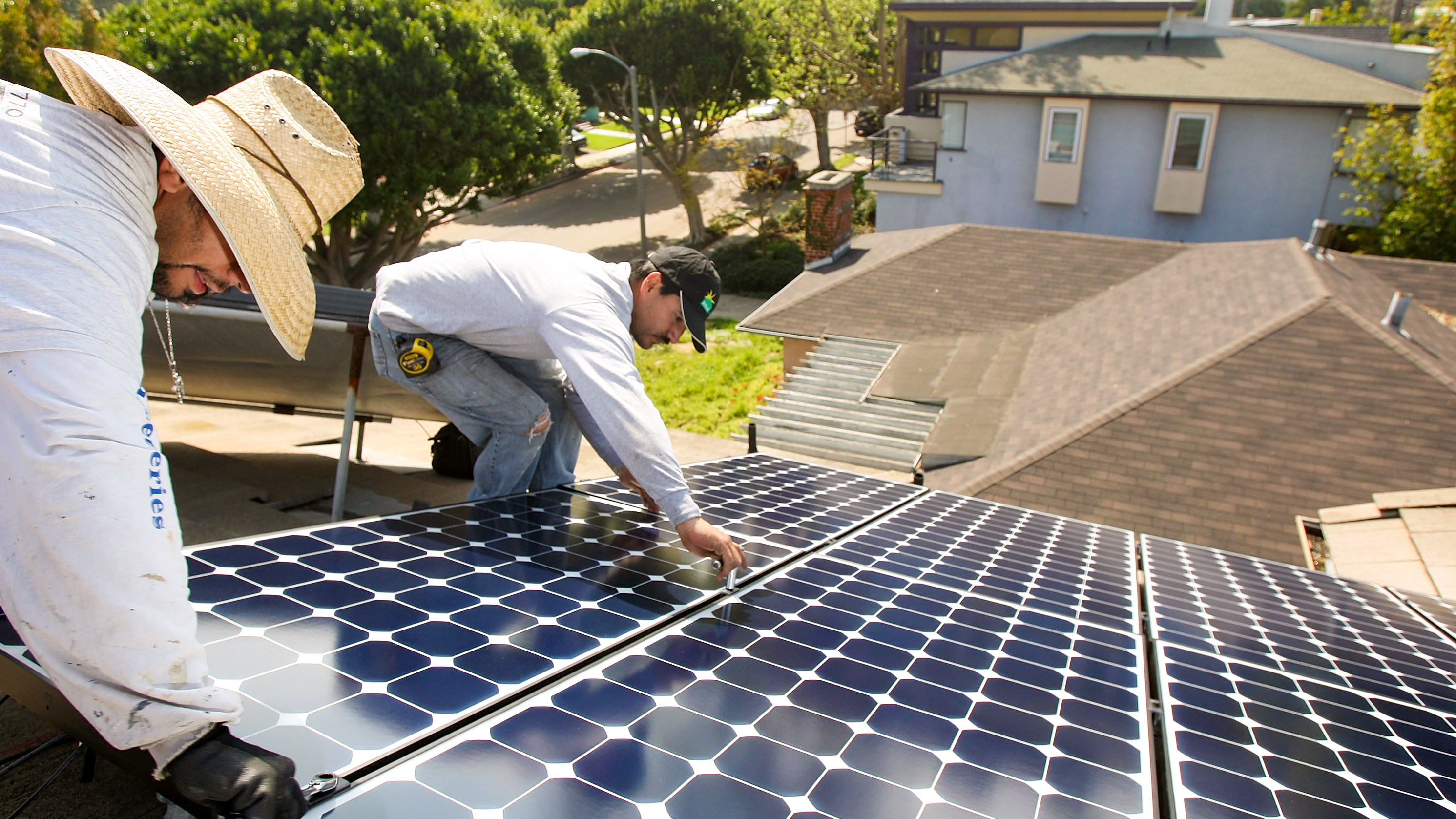 Work Crew Installs Residential Solar Power Panels In Santa Monica