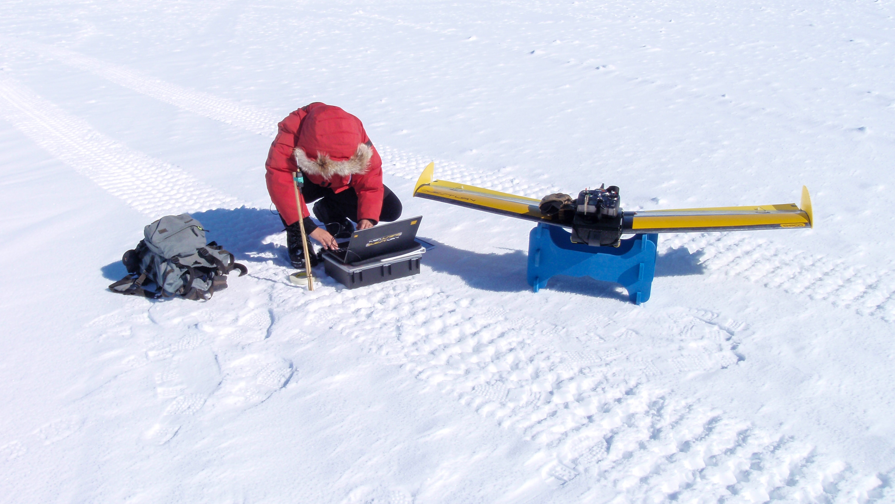 Millstein sitting in the snow assembling equipment