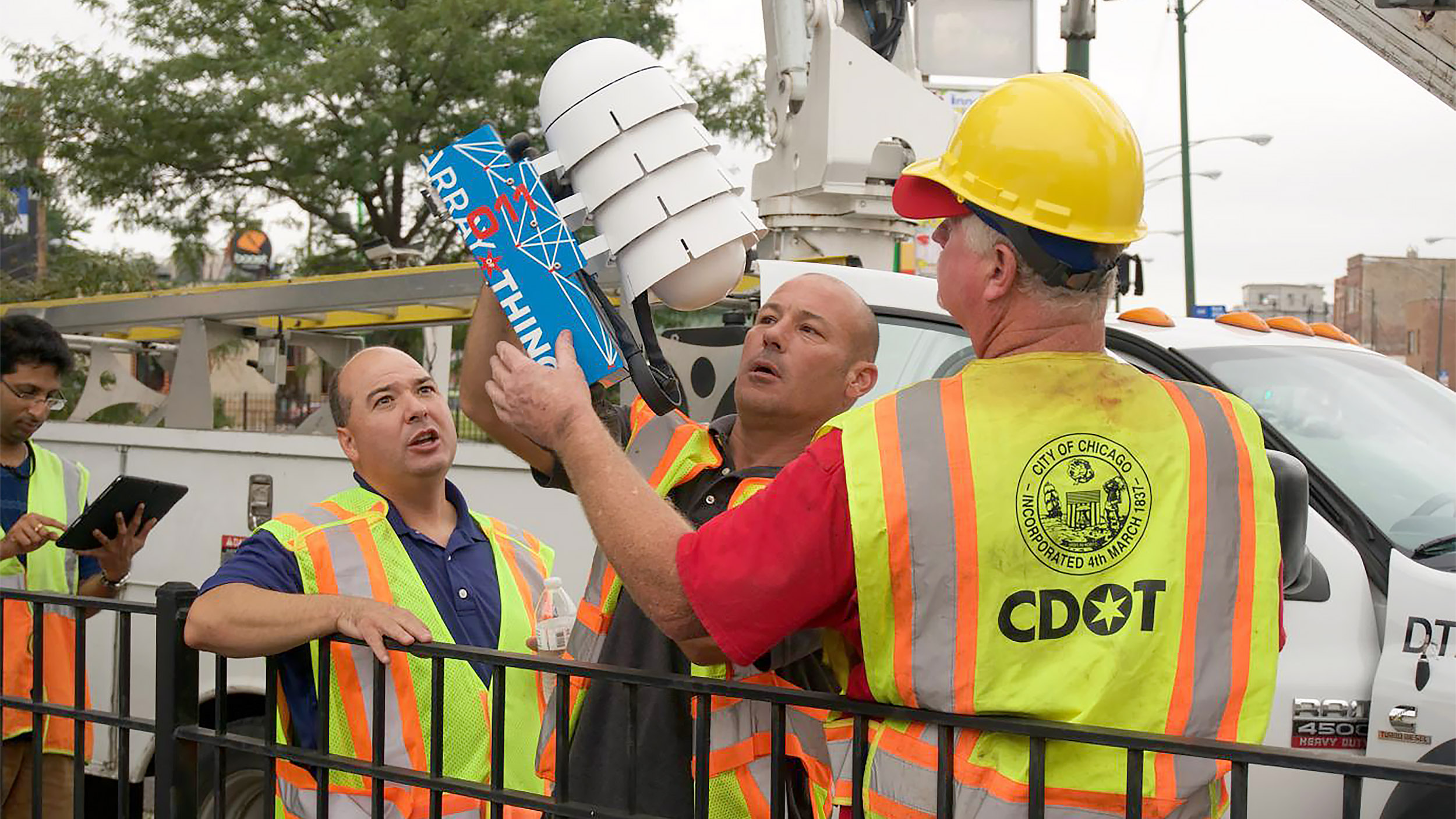 Array of Things unit held by City of Chicago workers on installation day