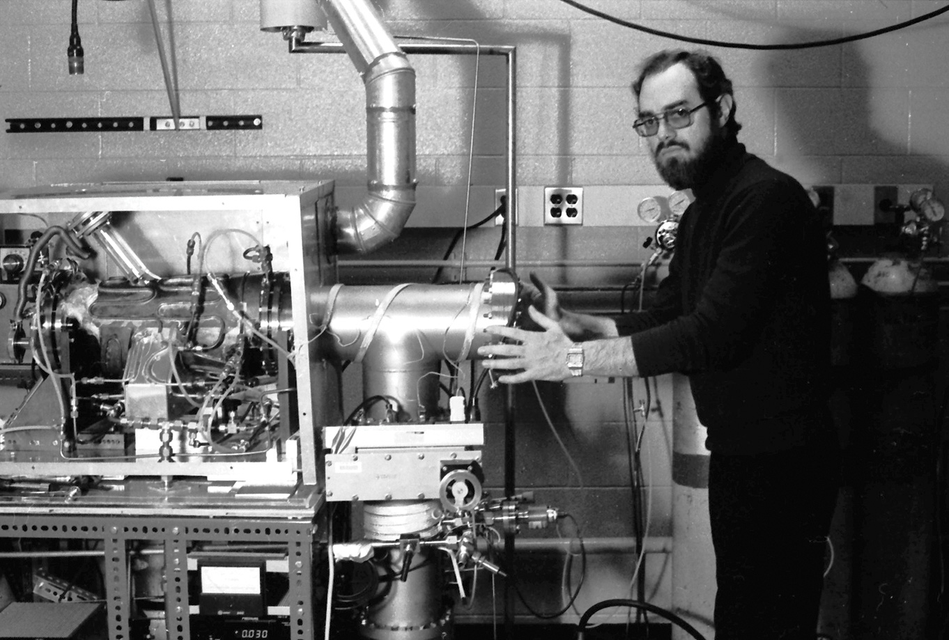 black and white photo of young President Reif in the lab