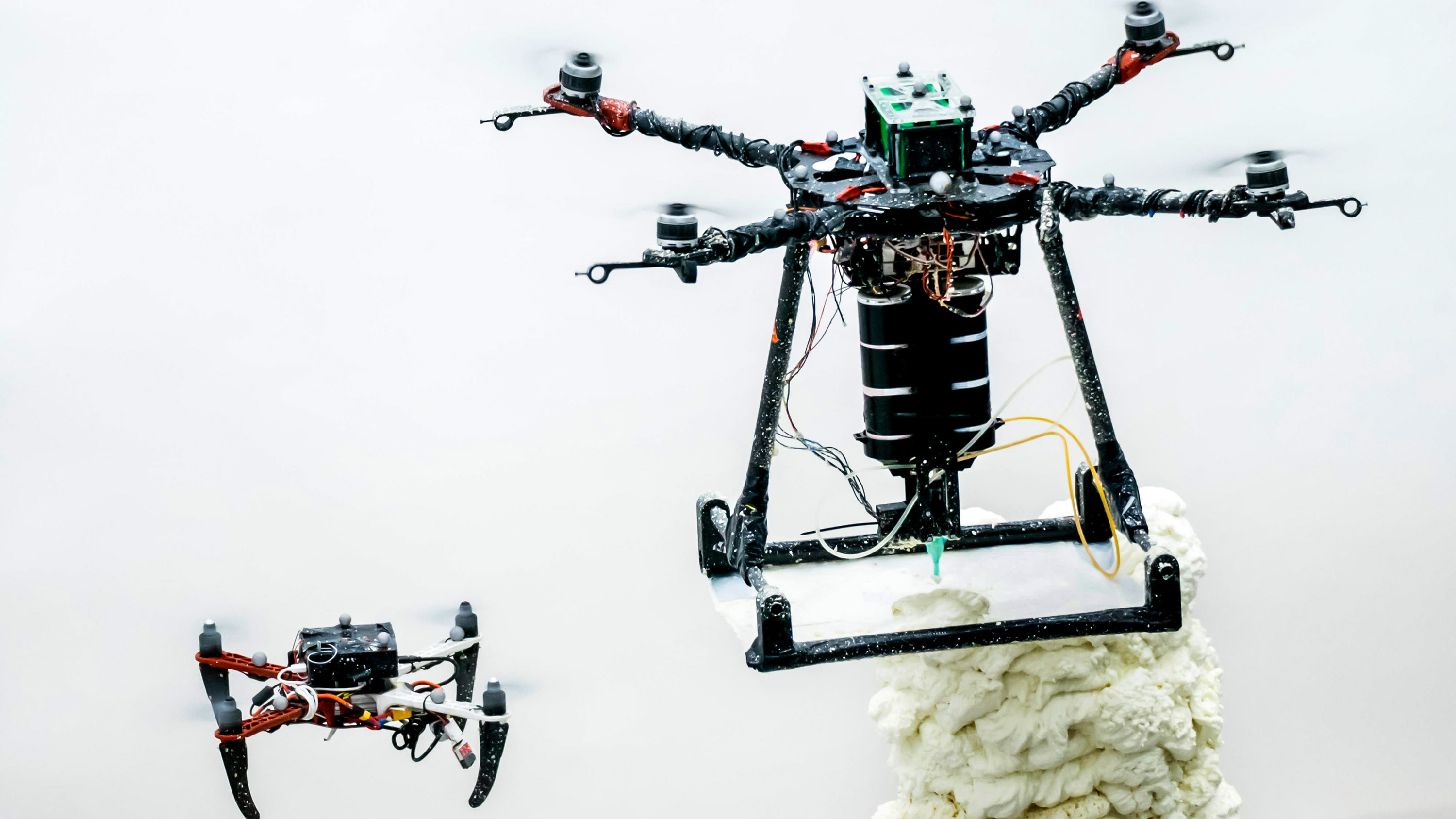 a #d printing drone guided by a scanning drone deposits material onto a structure