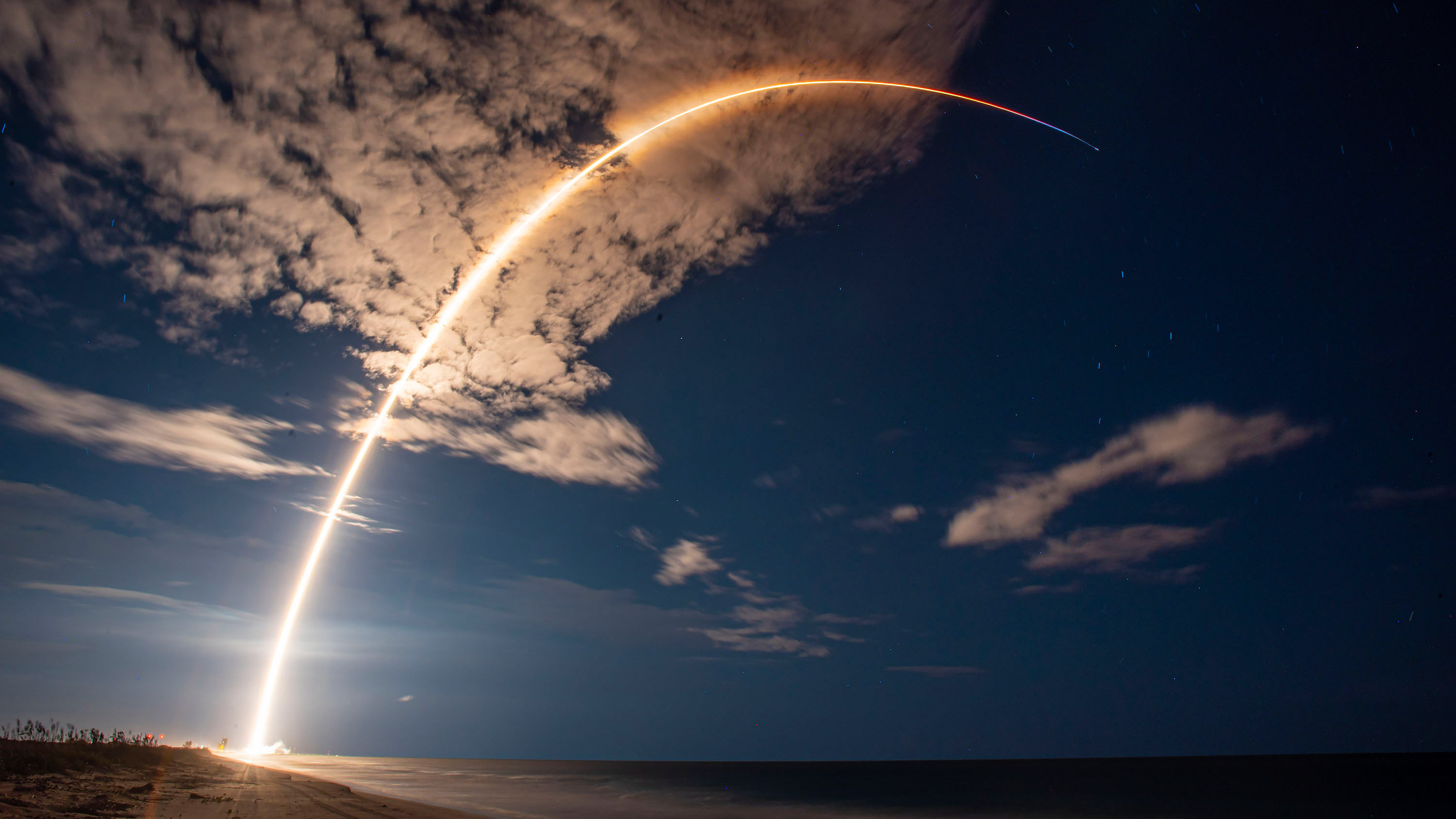 arc of satellite launch for Starlink in the night sky