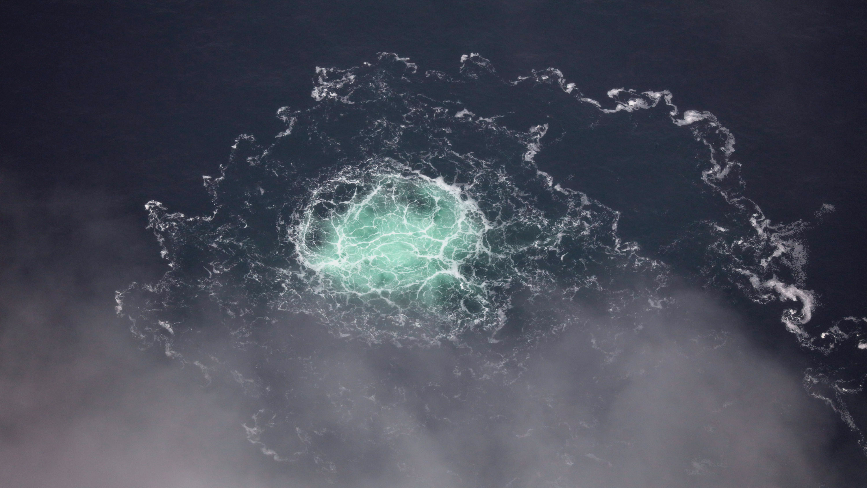 underwater gas creating a disturbance on the surface of the sea water.