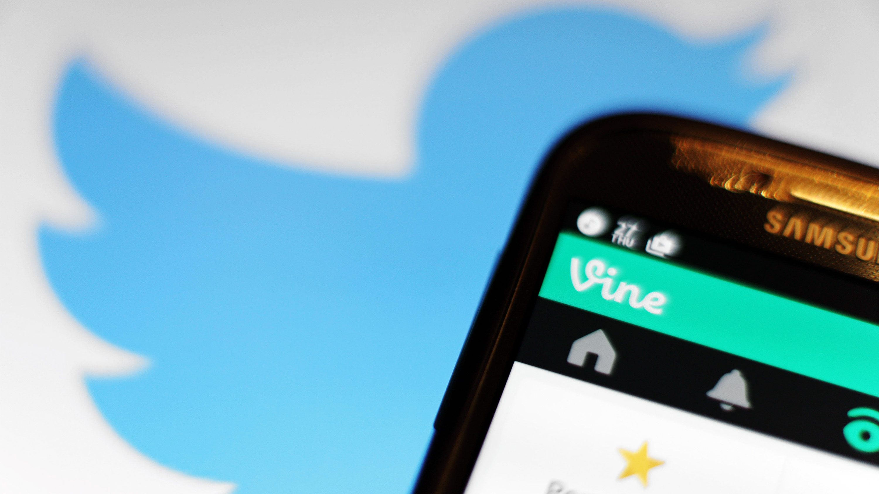 twitter logo behing a phone with Vine app