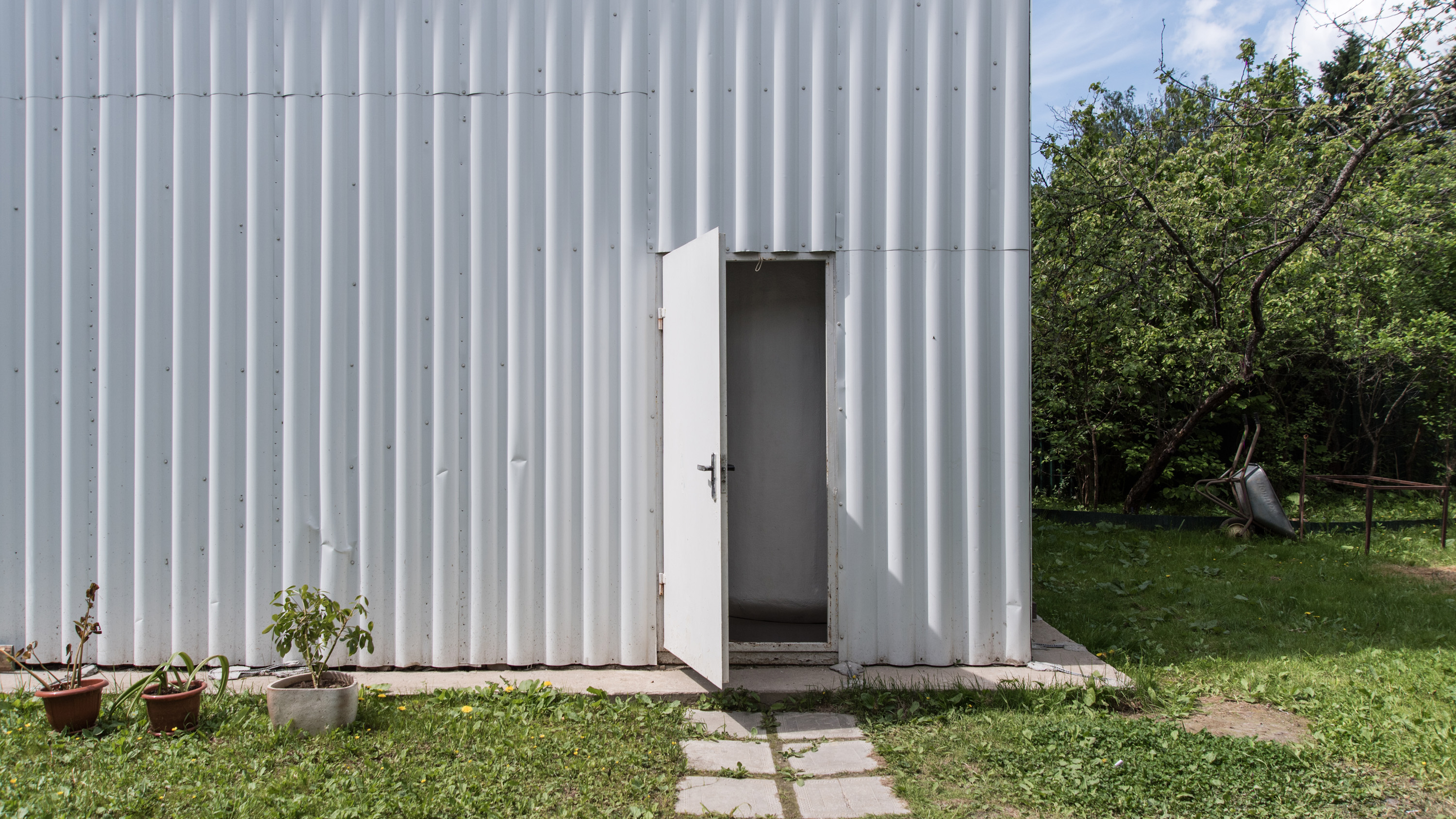 An open door in a corrugated metal building