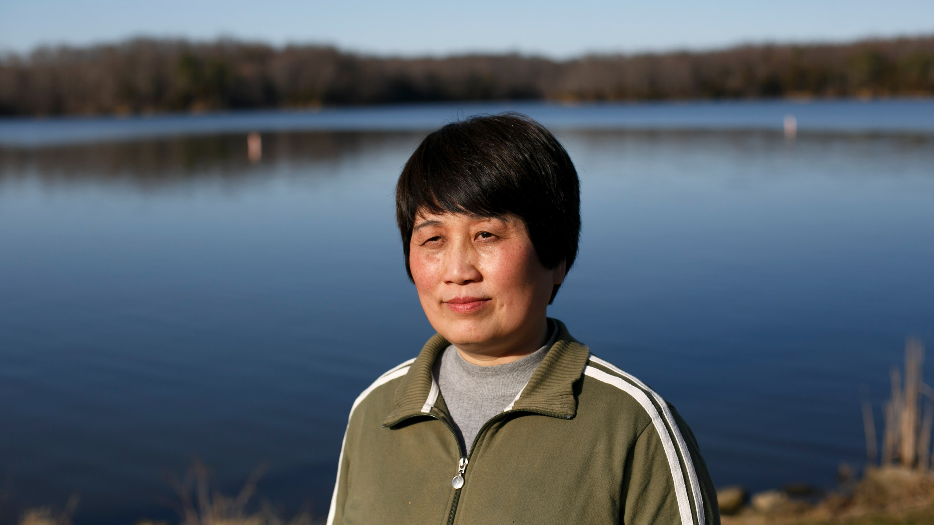 portrait of Sherry Chen outdoors by a lake