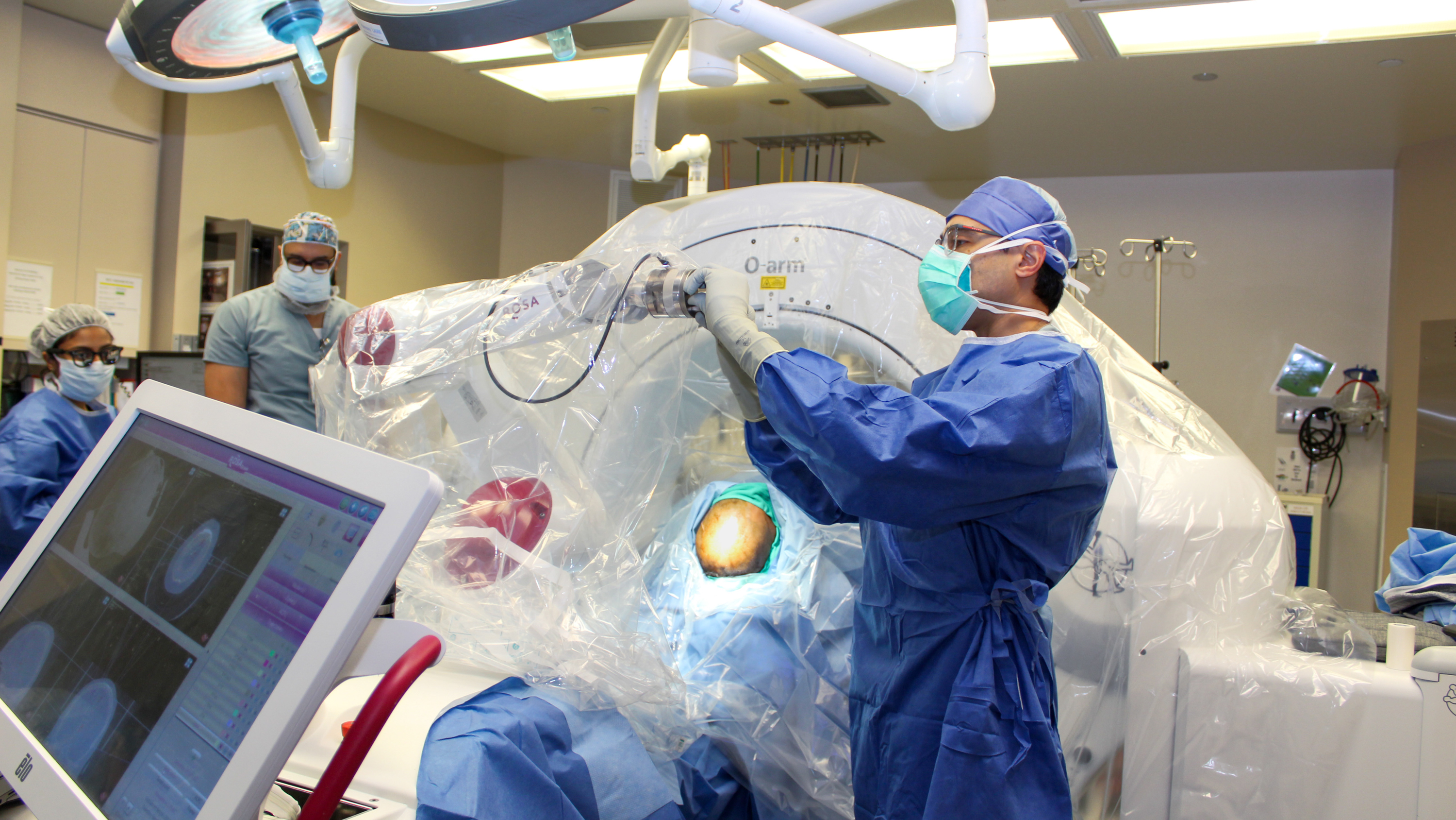 Doctors prepare a patient for deep brain stimulation procedure