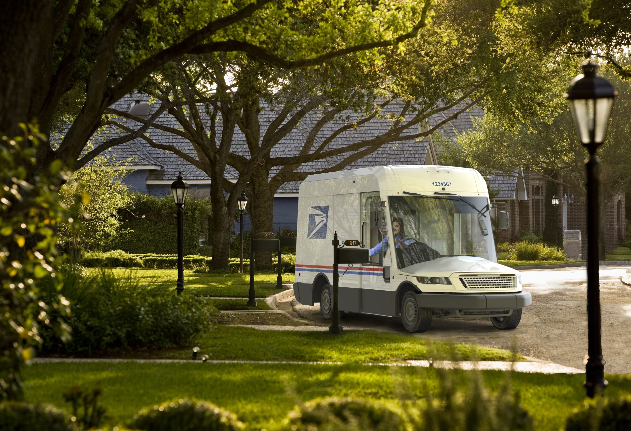 A futuristic mail truck at the end of a wooded street, with a postal worker leaning out the window to reach a mailbox