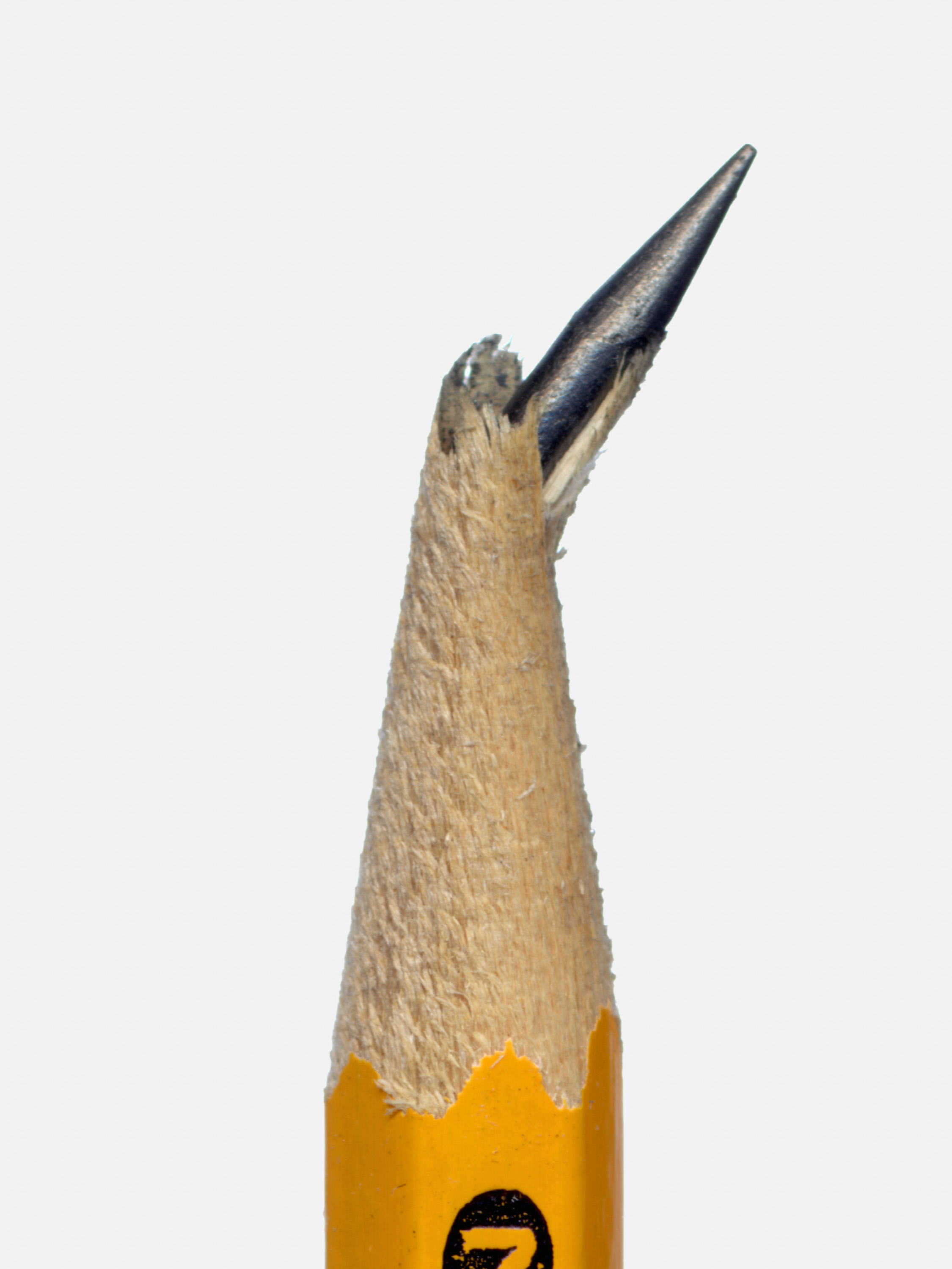 a yellow graphite pencil with the tip broken and tilting sharply askew