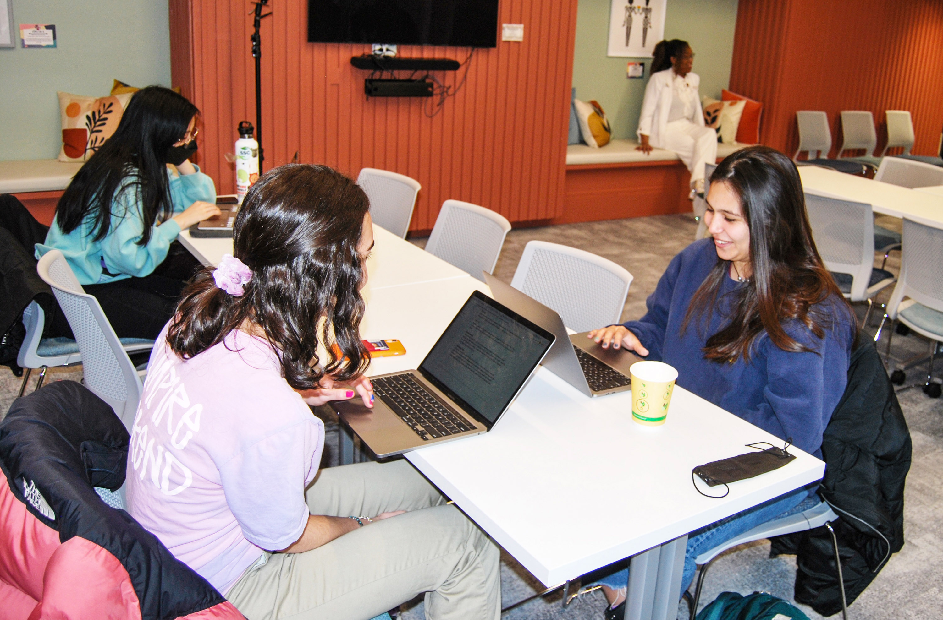 students at a table in the Cheney Room using laptops