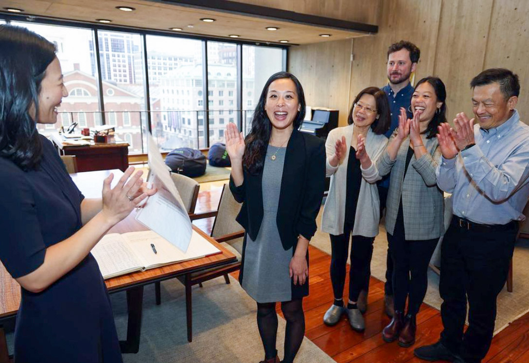 Tiffany Chu waves at camera excitedly while Mayor Wu and other staff applaud