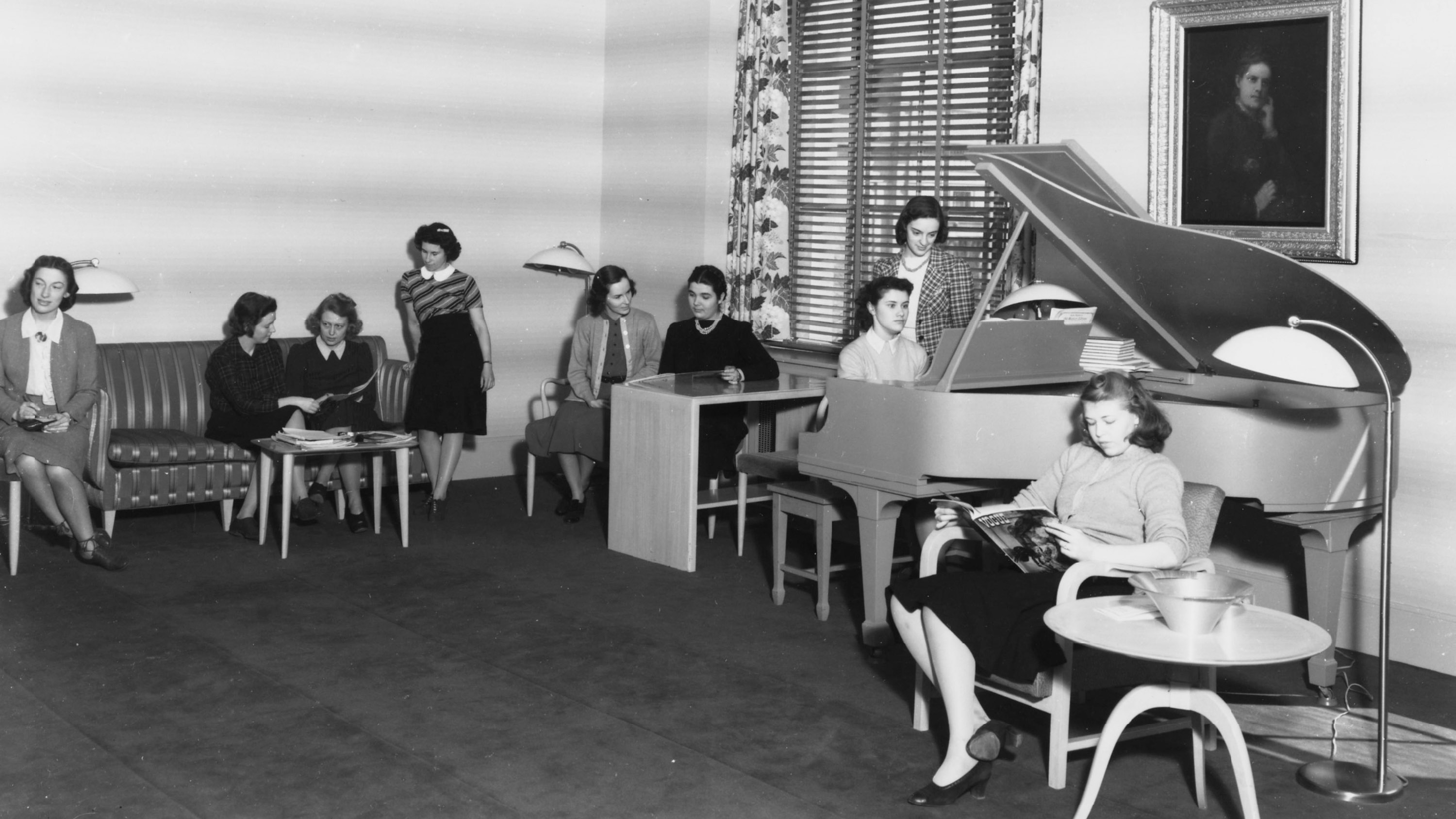 students in the Cheney room, talking, reading and at the piano in the 1940s