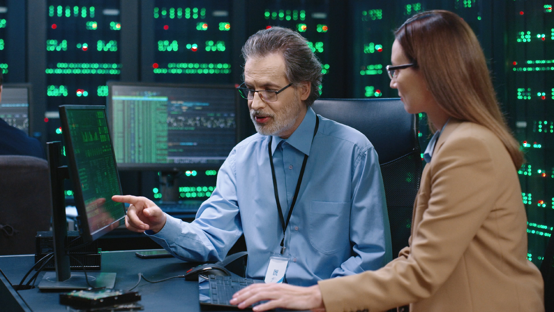 A stock image of two colleagues working in a data center
