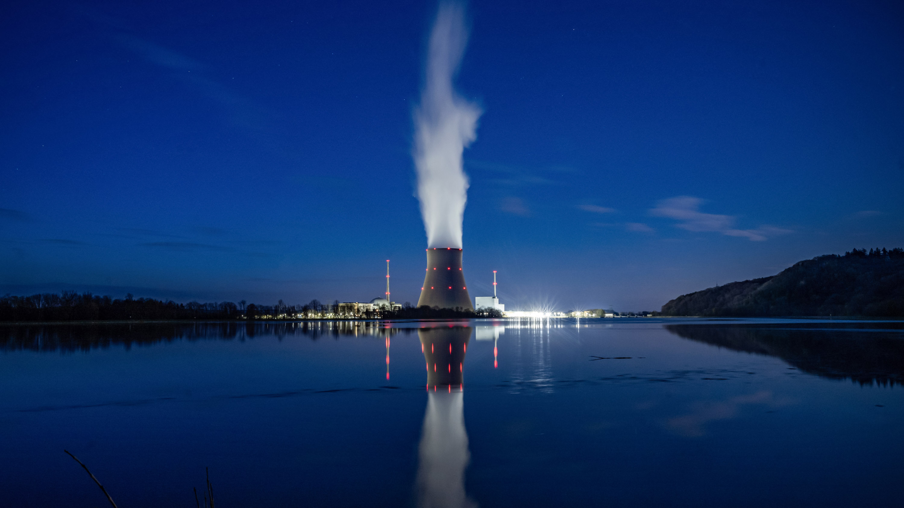 Water vapor rises from the cooling chamber of the Isar 2 nuclear power plant at night