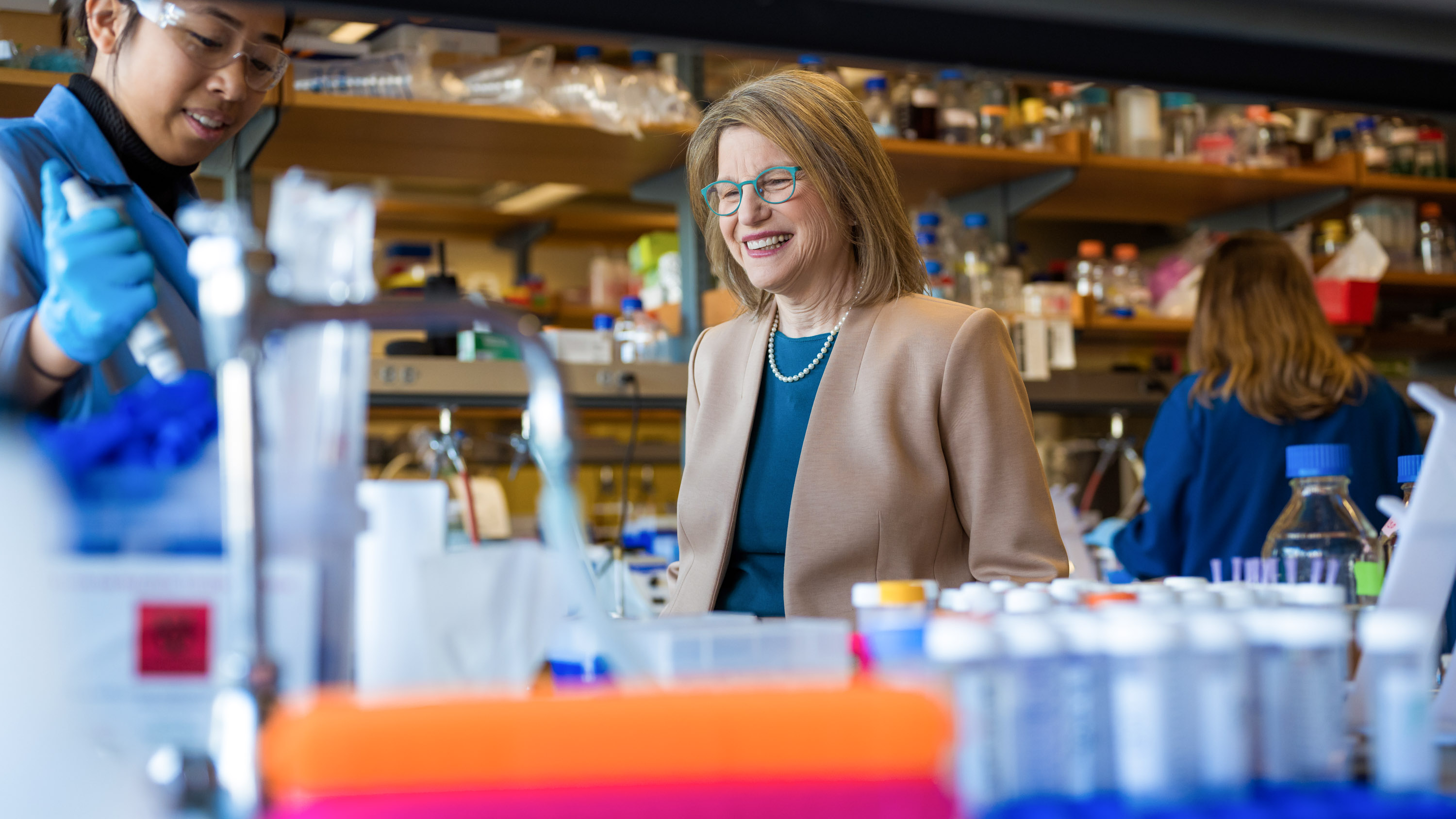 Sally Kornbluth visits a lab where scientists are working