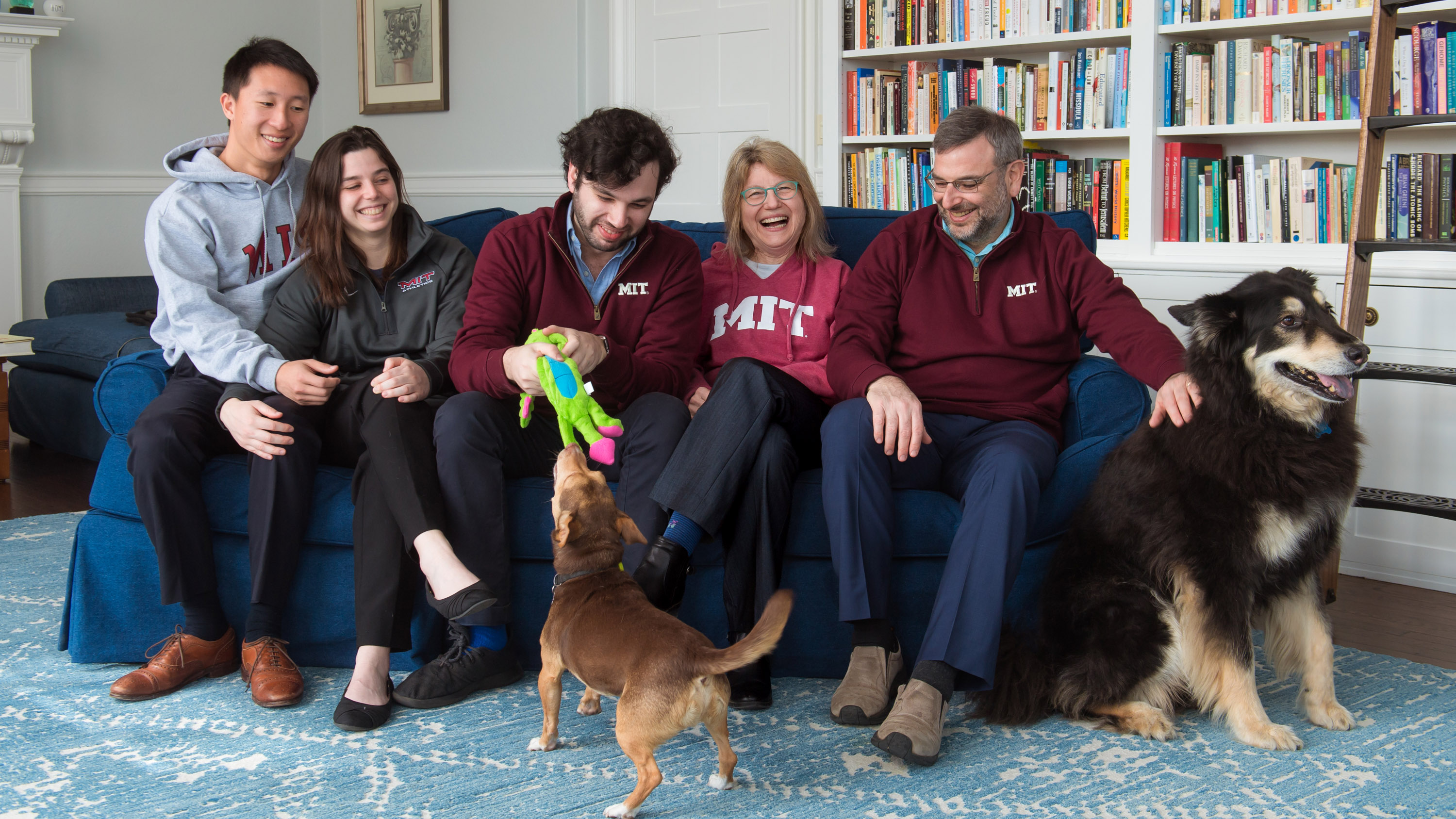 Sally Kornbluth on a couch with her family and two dogs