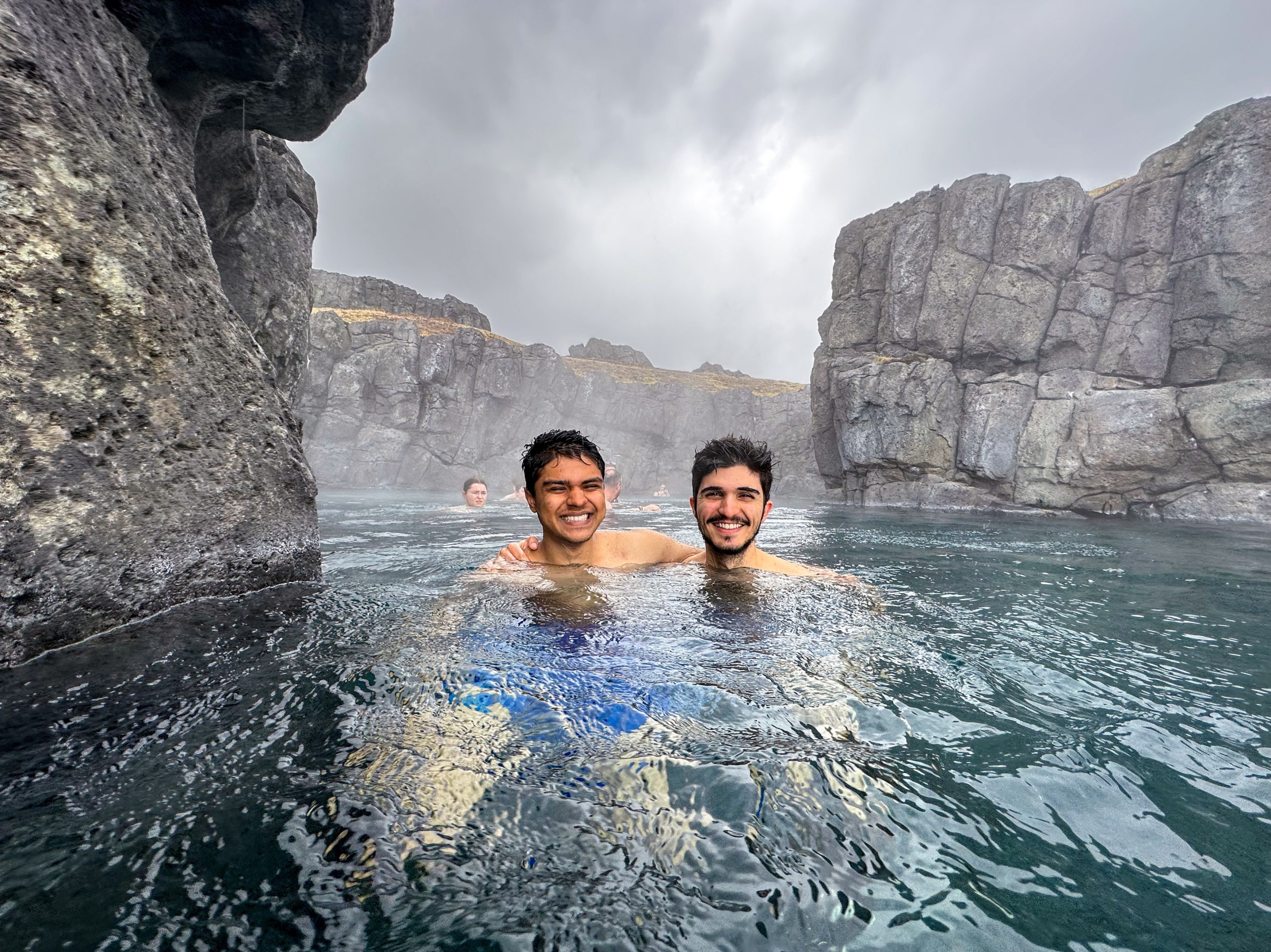 two students soaking in a hot spring in Iceland