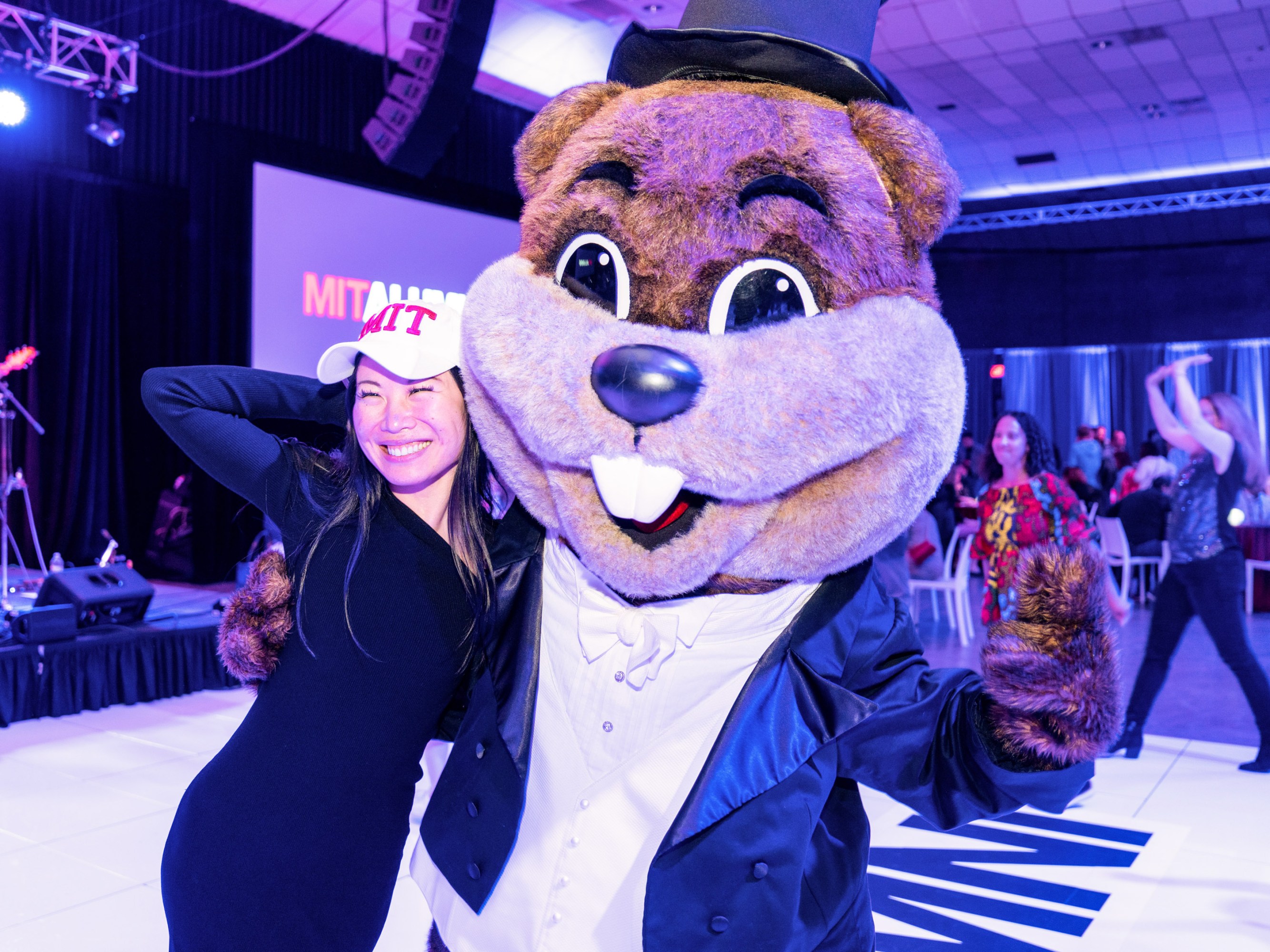 Alumni poses with Tim the Beaver