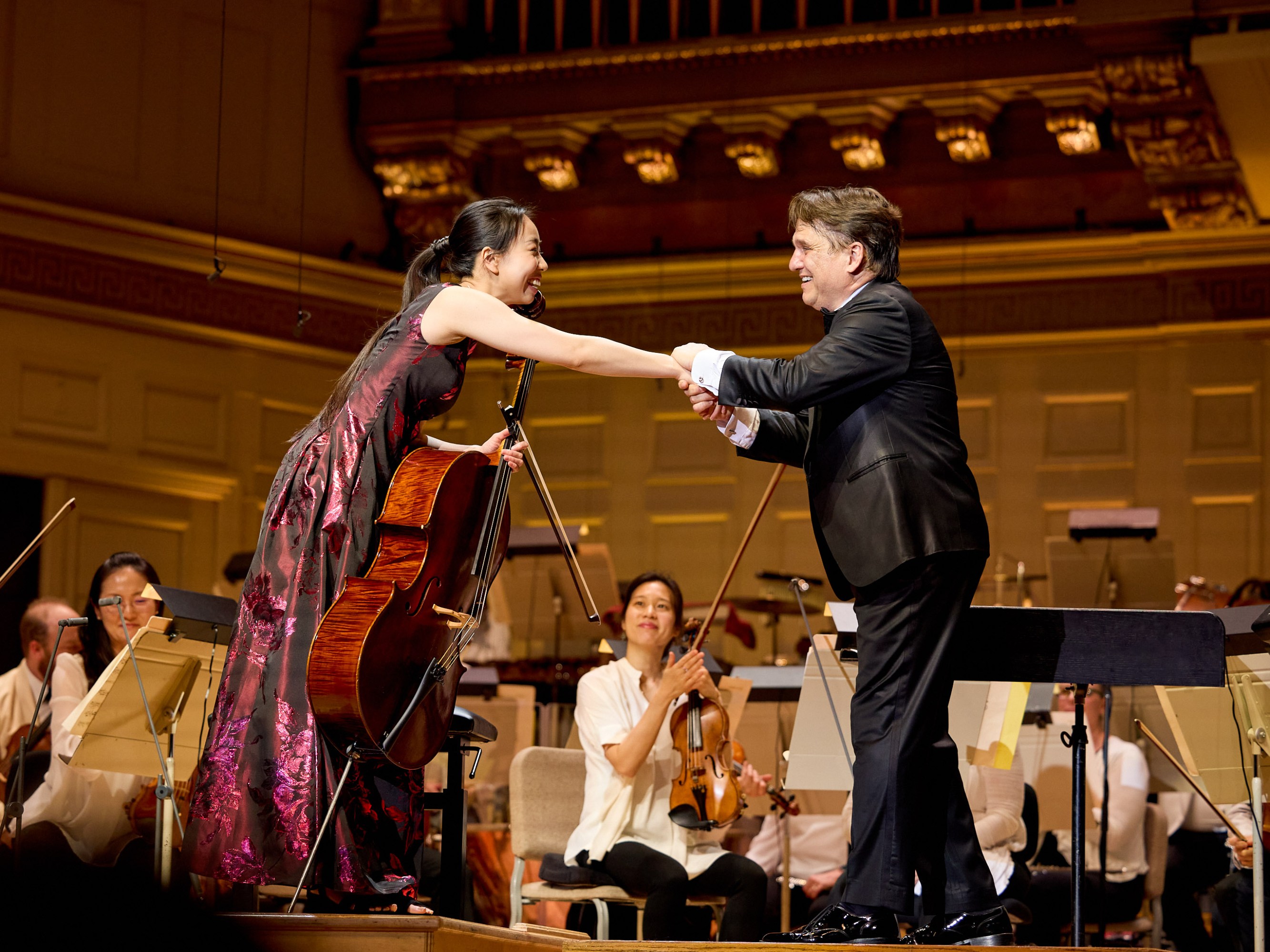Valerie Chen reaches out to take the hand of the conductor on stage