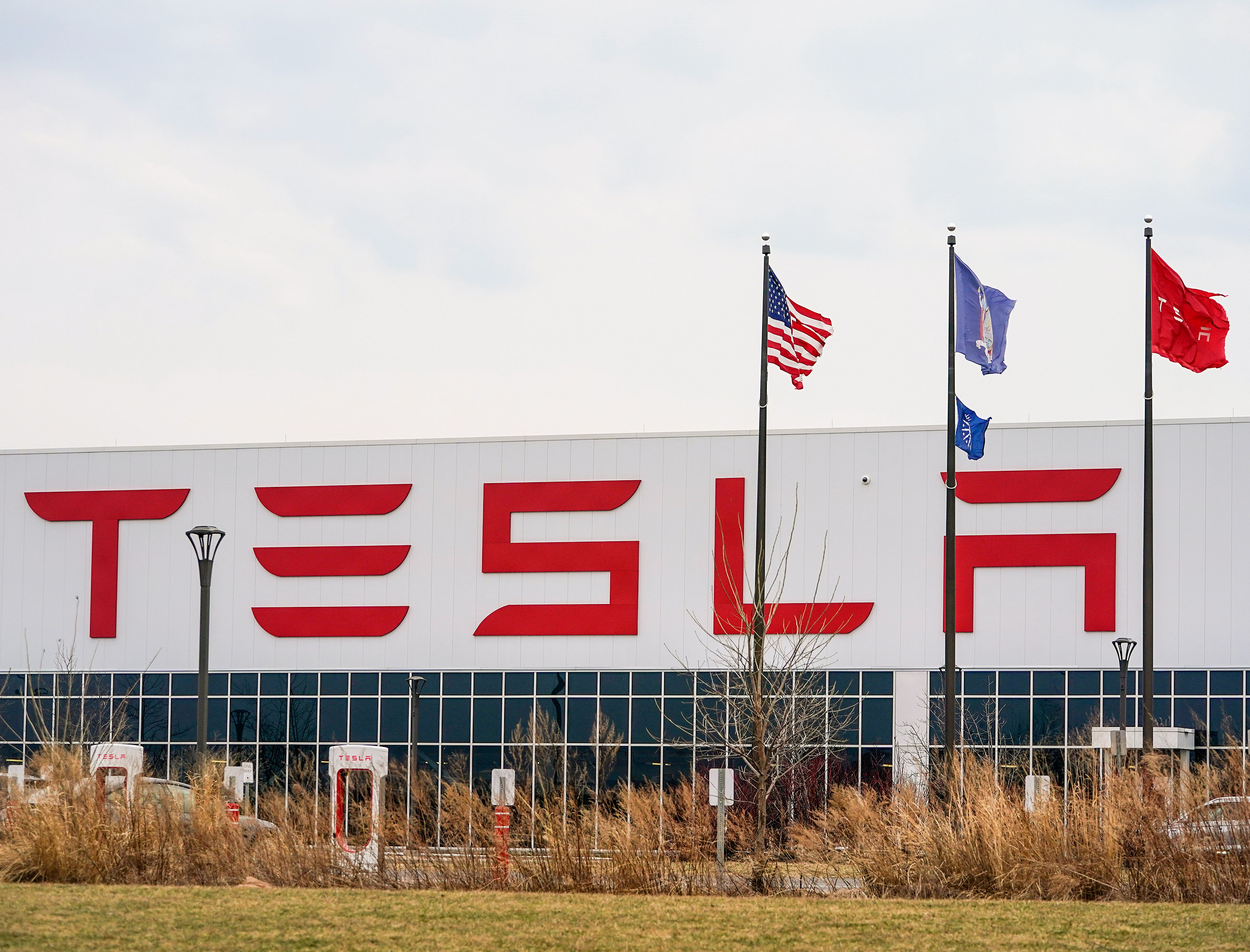 The facade of the Tesla Gigafactory in Buffalo New York, with the Tesla logo in massive letters on the outside.